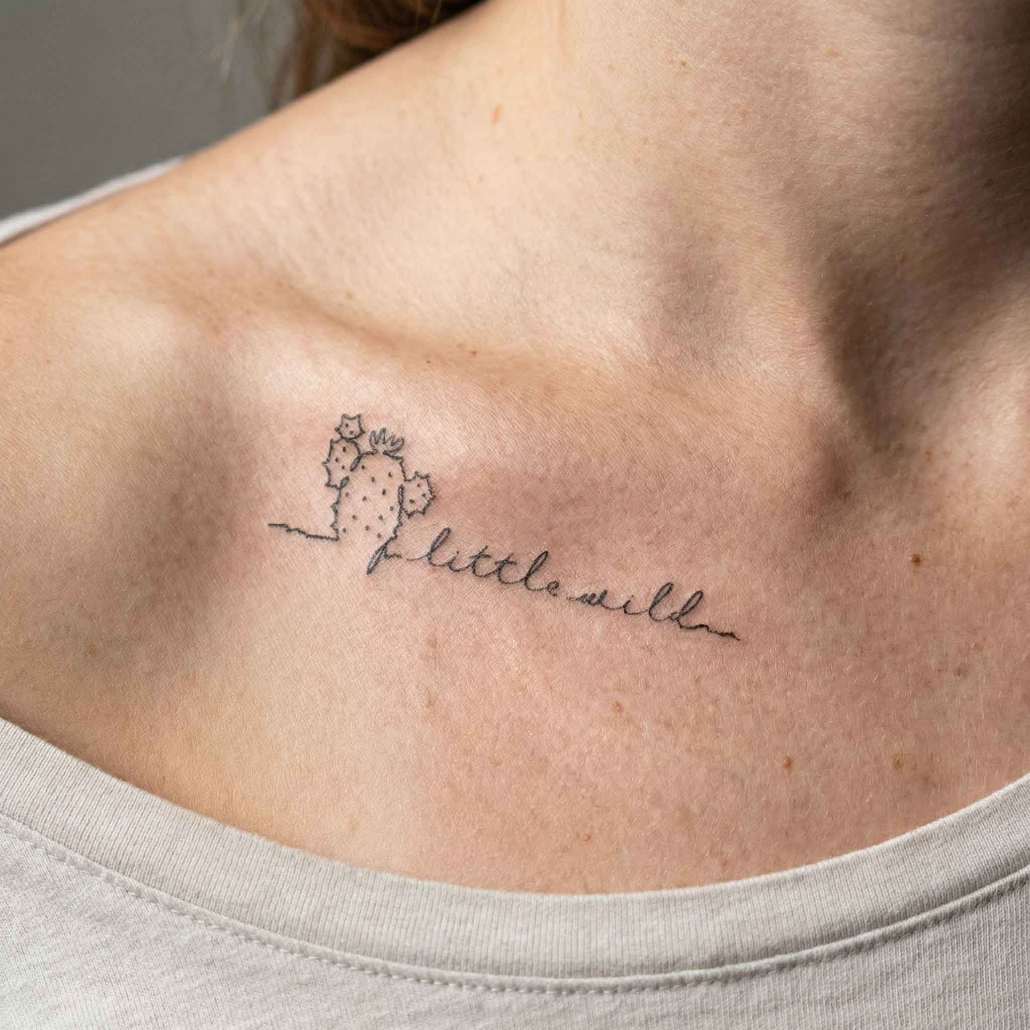 Tiny handwritten quote tattoos with cactus designs worn on clavicle