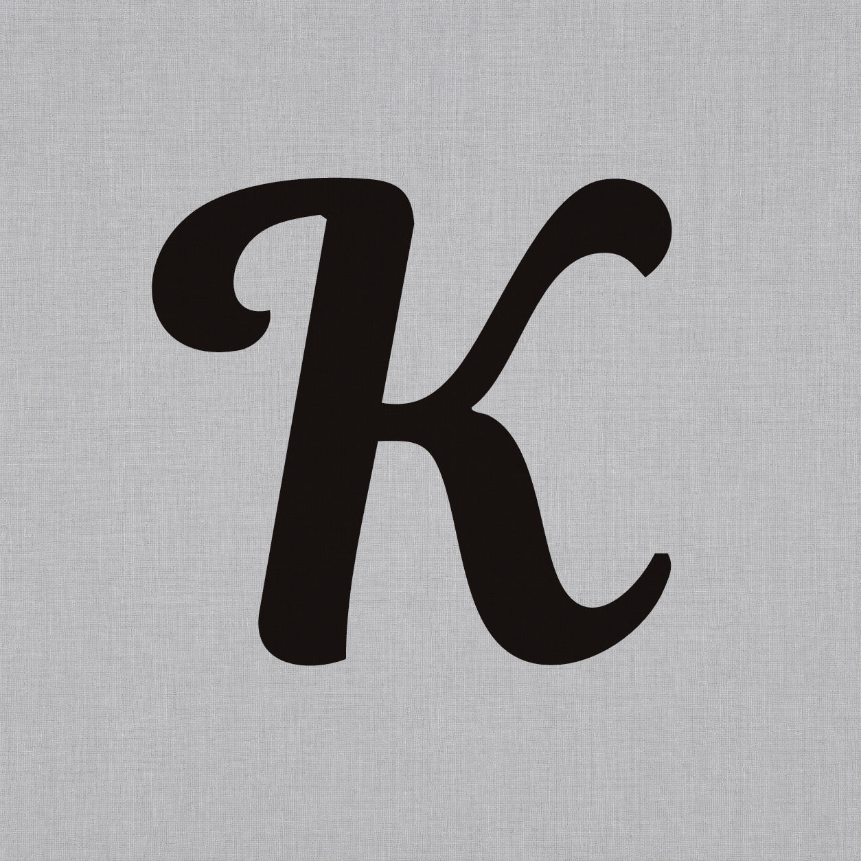 Temporary tattoo design featuring a bold black uppercase letter K in a clean minimal style.