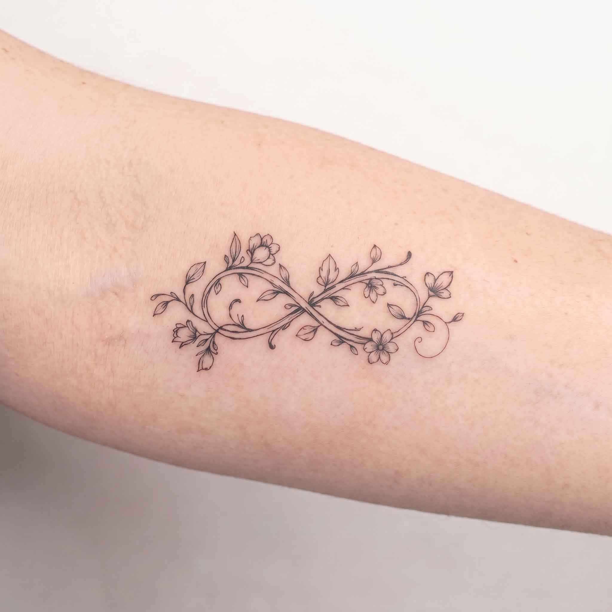 Botanical infinity symbol  temporary tattoo on forearm