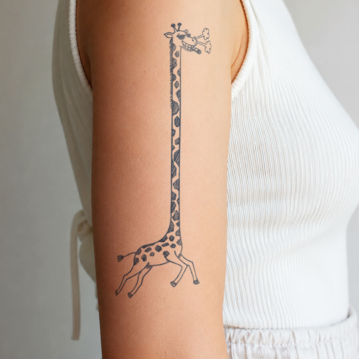 Cartoon giraffe temporary tattoo on arm