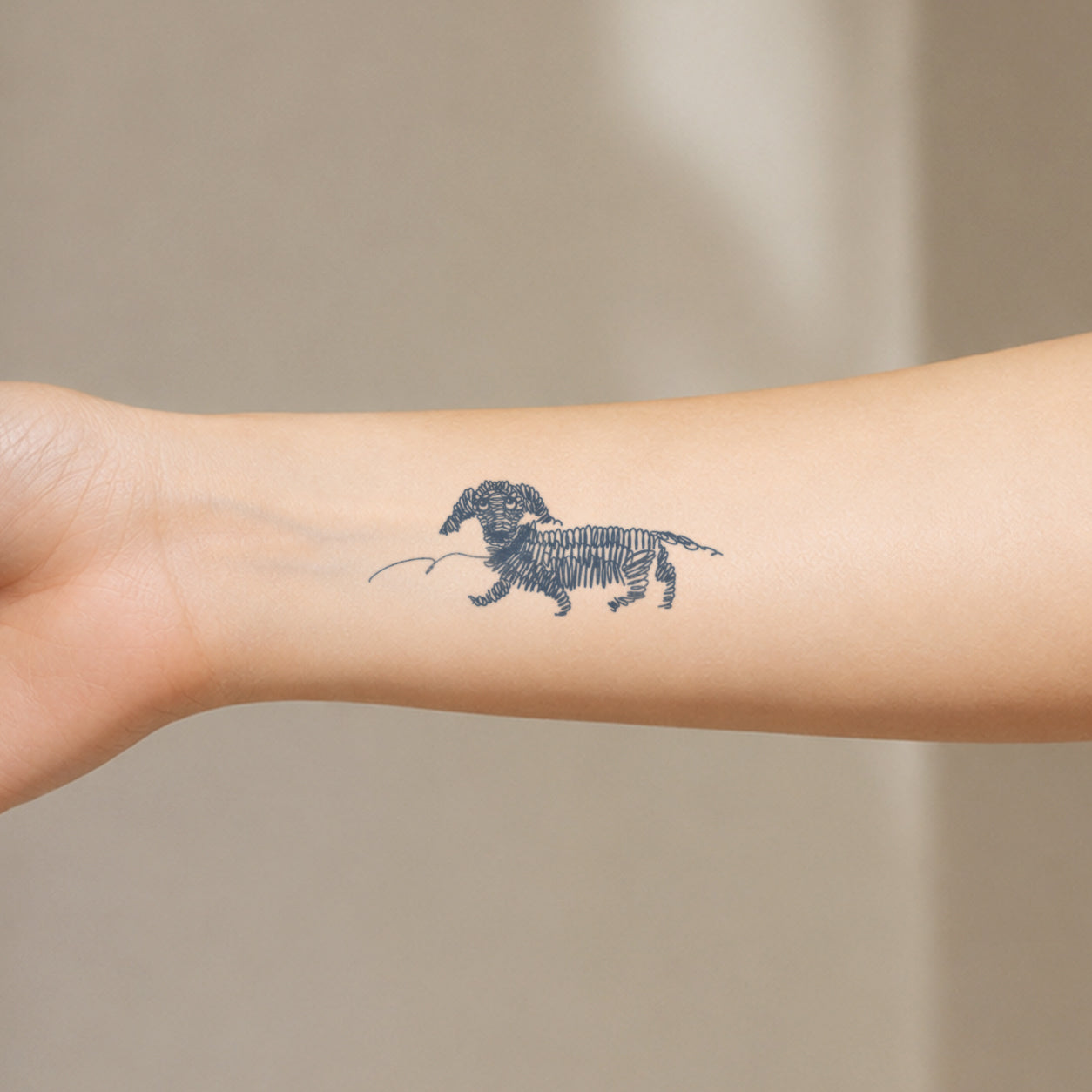 Detailed fine line tattoo featuring a small dachshund dog illustration. This unique temporary tattoo design combines a playful pet theme with vintage sketch-style artwork.