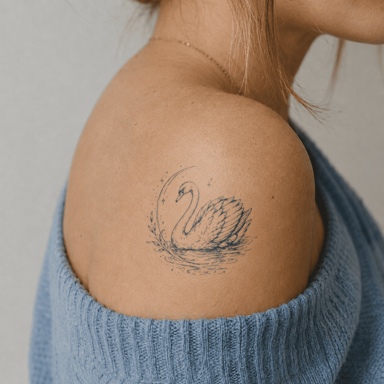 Fine line swan temporary tattoo featuring on shoulder
