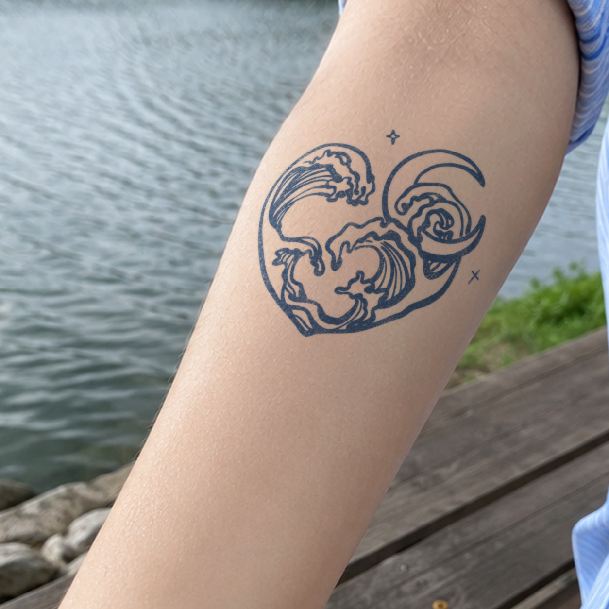 Temporary forearm tattoos featuring a heart-shaped ocean wave, crescent moon, and small star accents.
