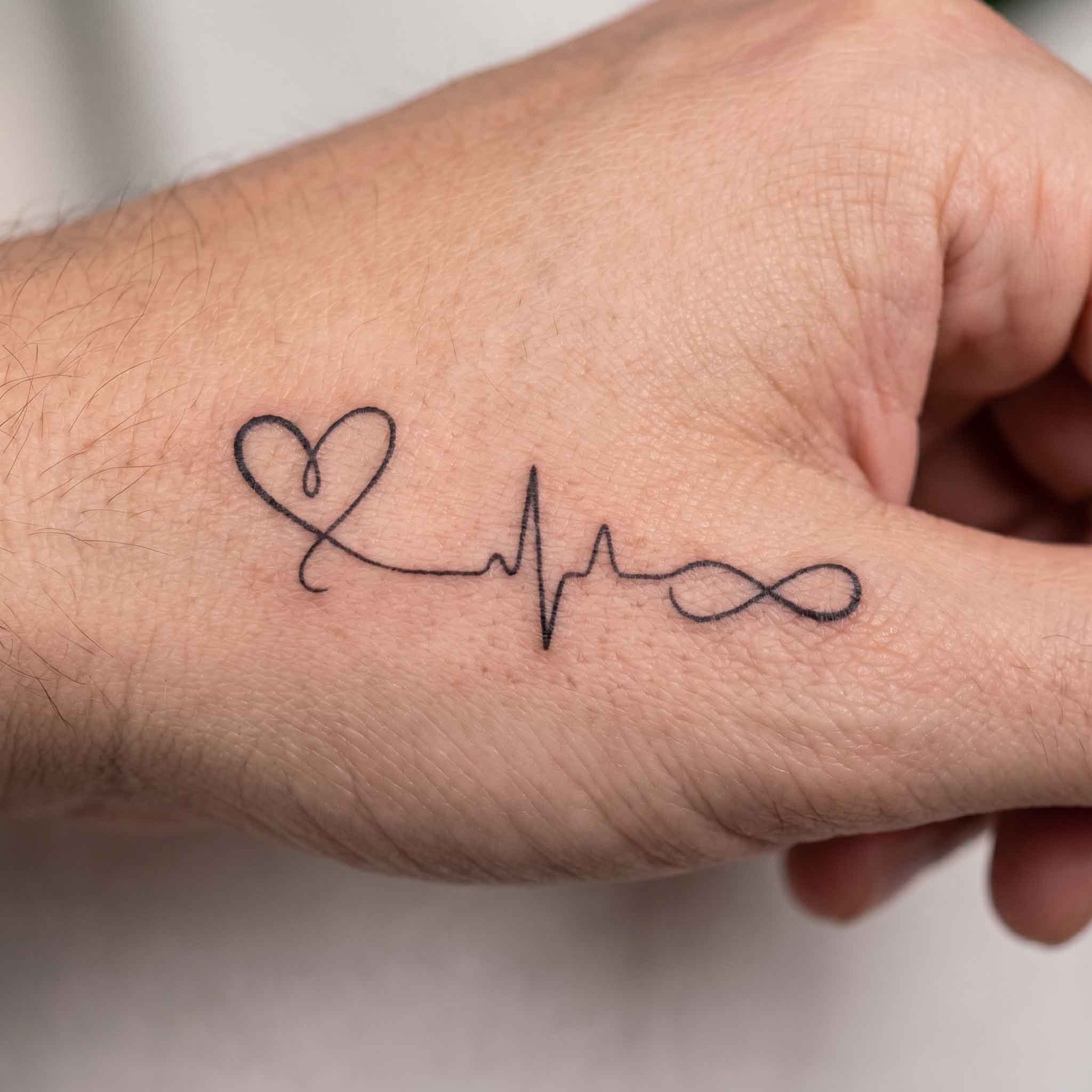 Infinite heart heartbeat temp tattoo on hand
