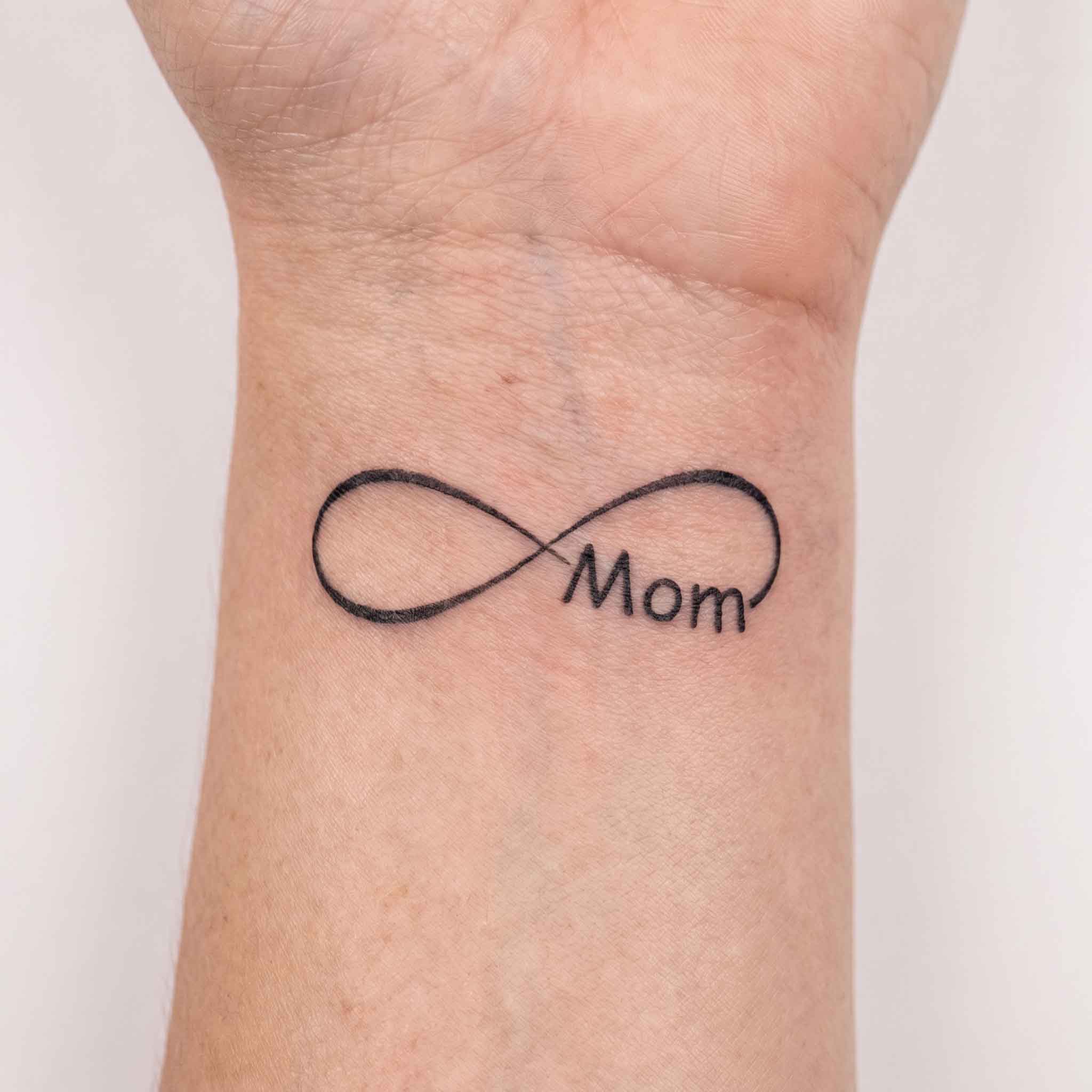 Infinity & Mom lettering wrist temporary tattoo on inner wrist