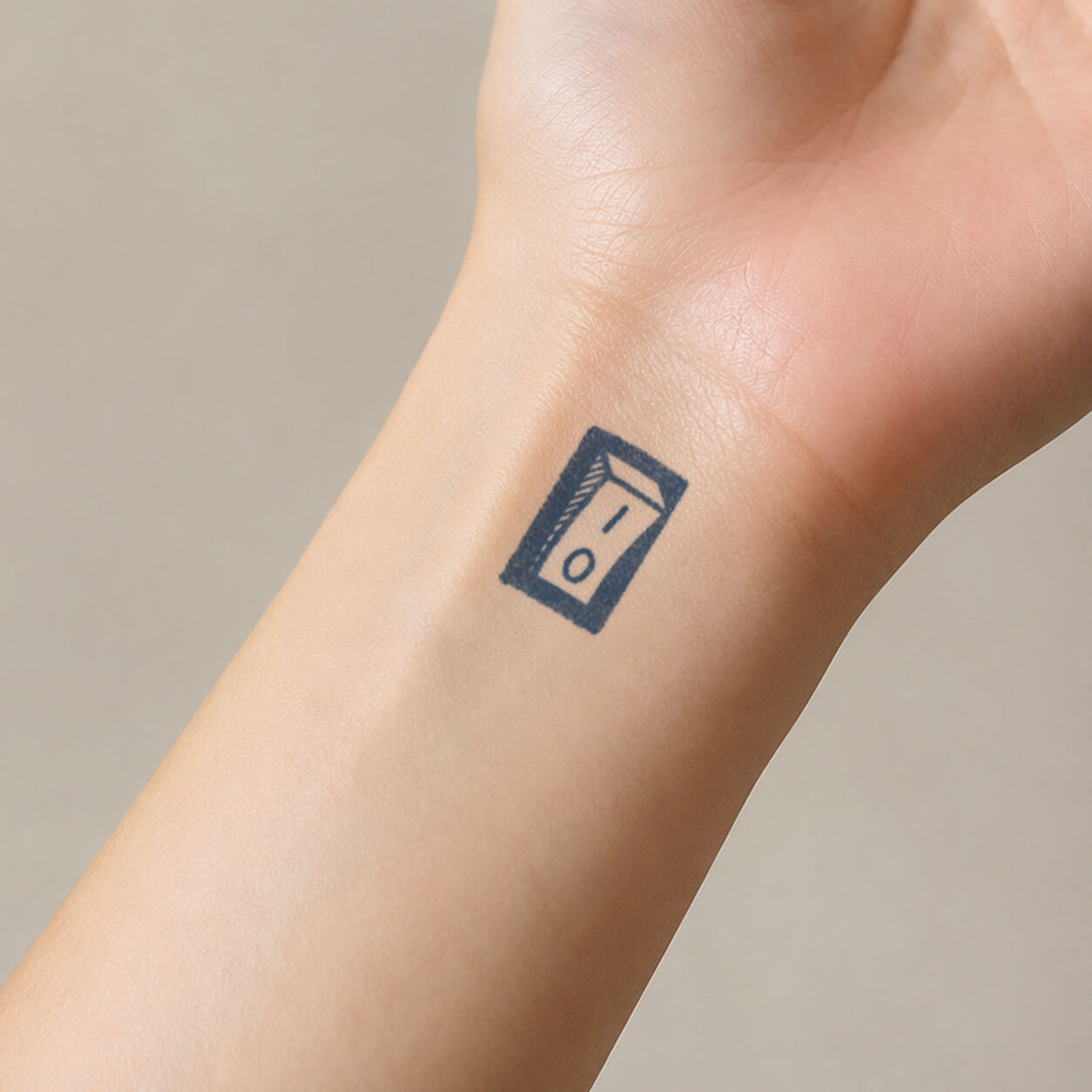 Minimal on-off switch temporary tattoo sticker displayed on the inner wri