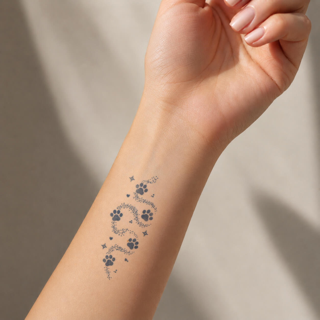 Delicate paw print design with dotted details and small stars placed on the wrist, featuring a meaningful pet temporary tattoo inspired by love for animals and companionship.