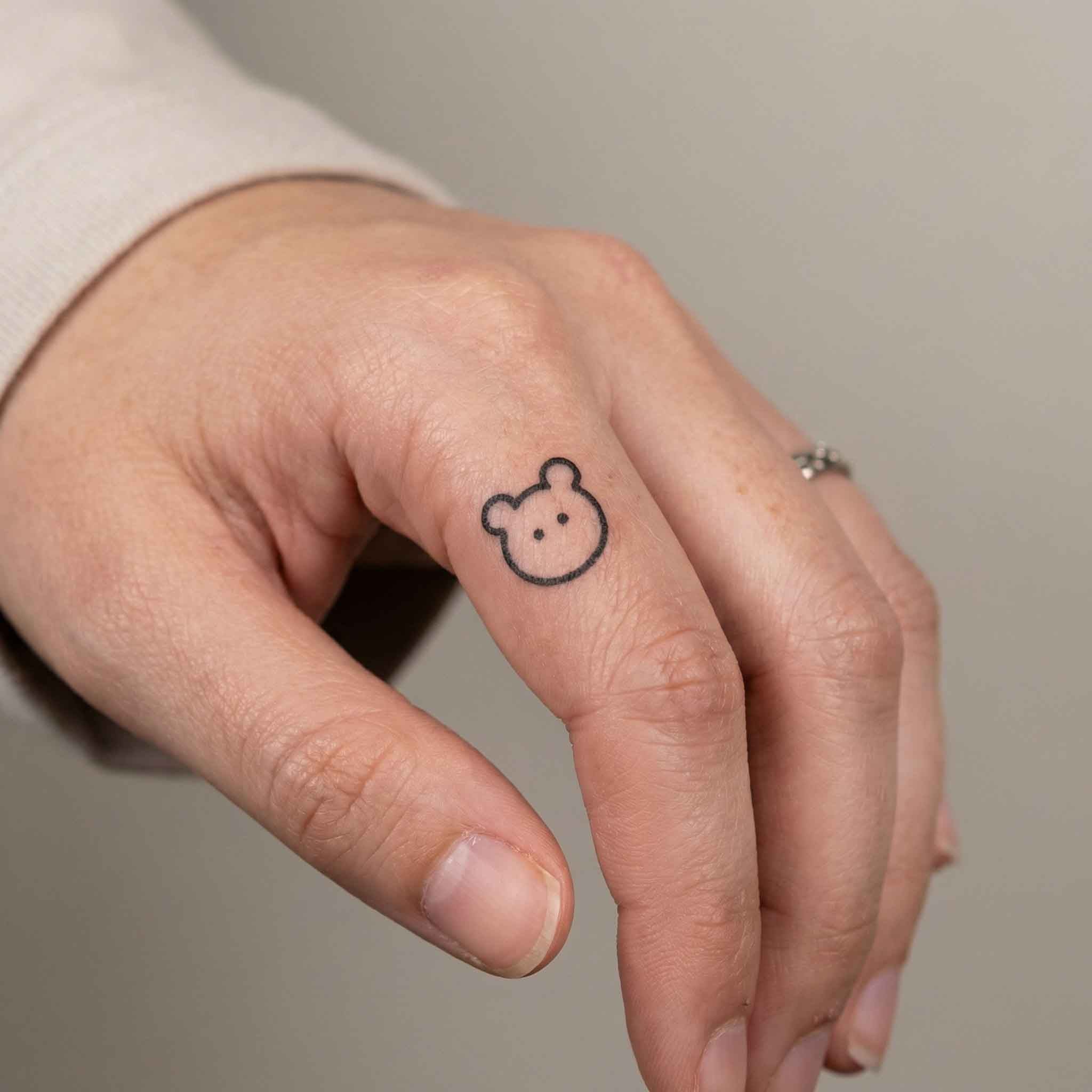 Small animal temp tattoos worn on finger in cute minimalist style