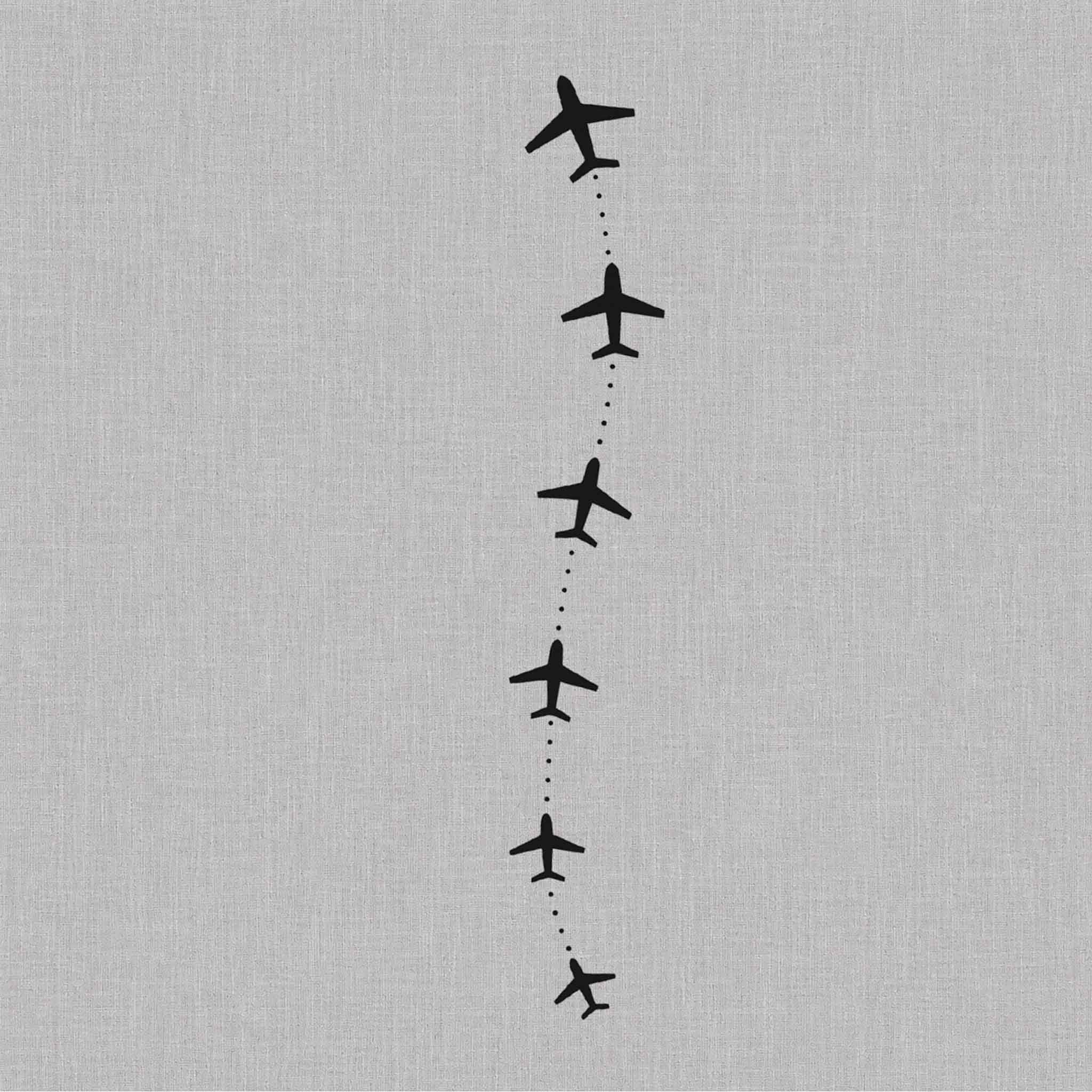 Minimalist flight path tattoo with ascending airplane silhouettes
