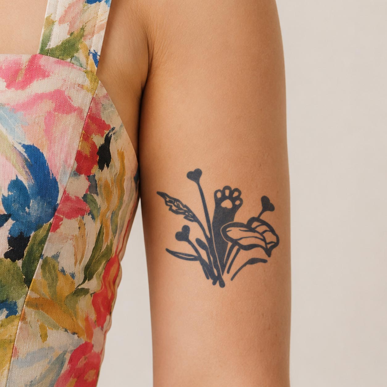 Temporary arm tattoos featuring a flower bouquet with leaves, heart-tipped stems, and a paw print.
