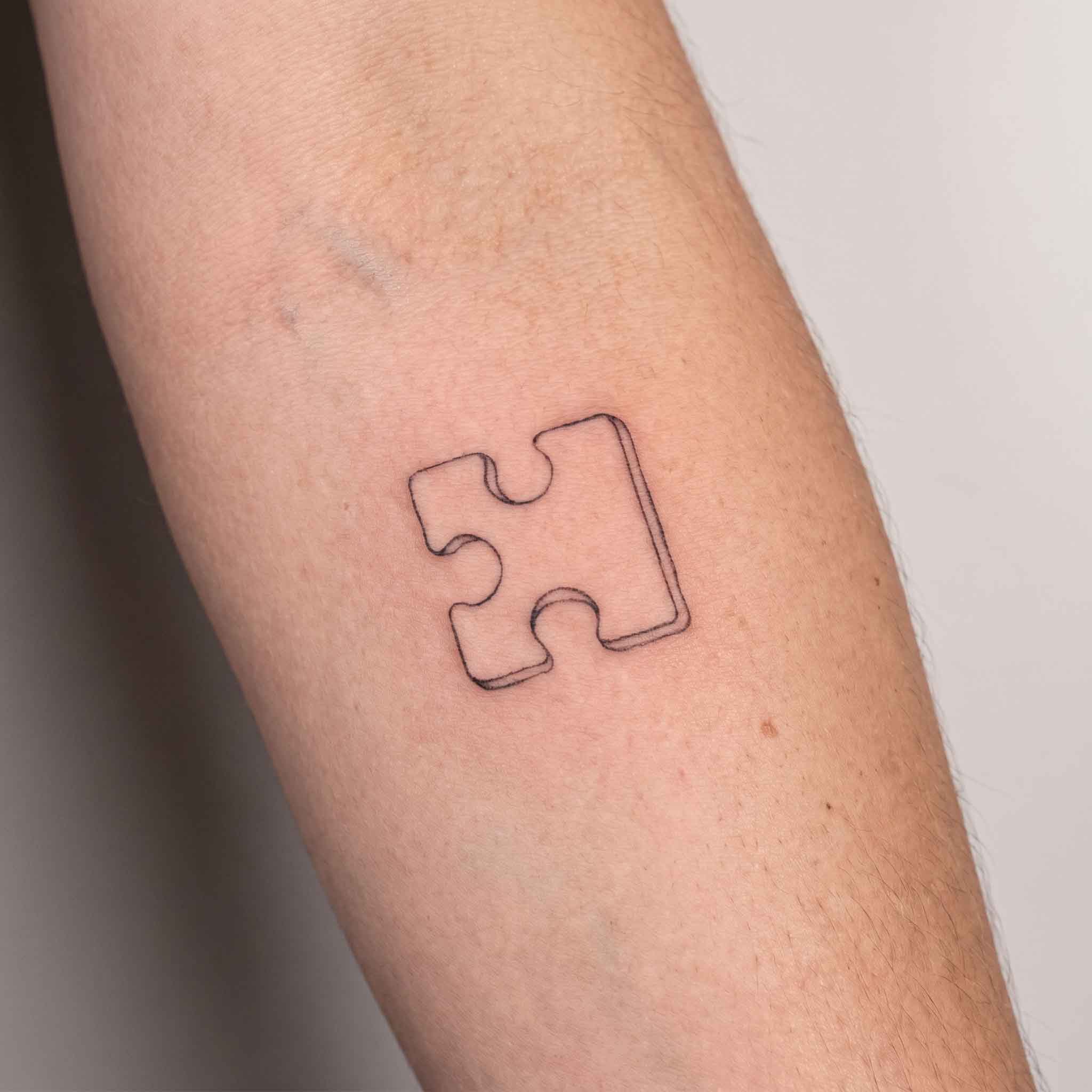 Puzzle piece small temporary tattoo on inner forearm