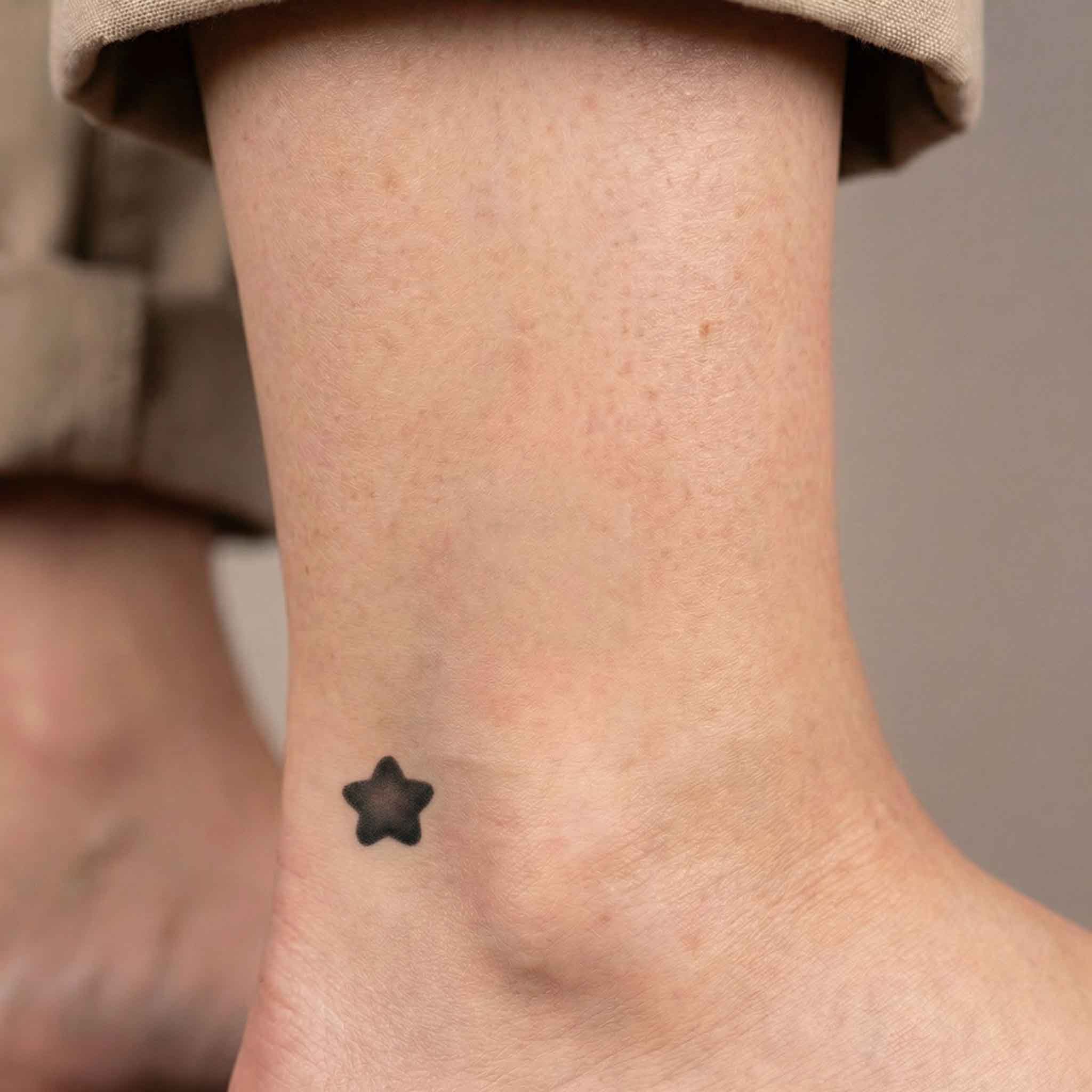 Small  black star temp tattoos on ankle