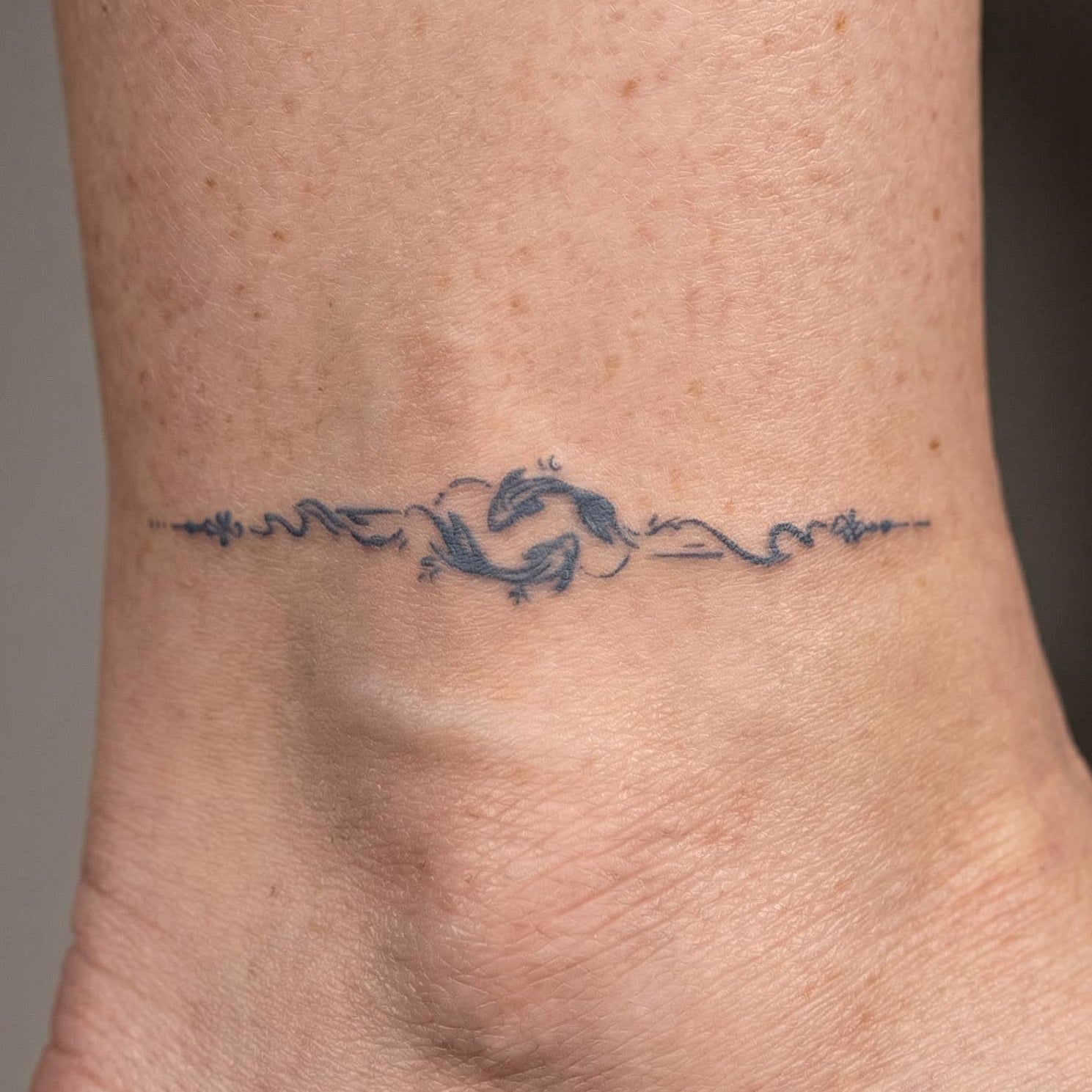 Minimal twin fish line realistic fake tattoos on the wrist