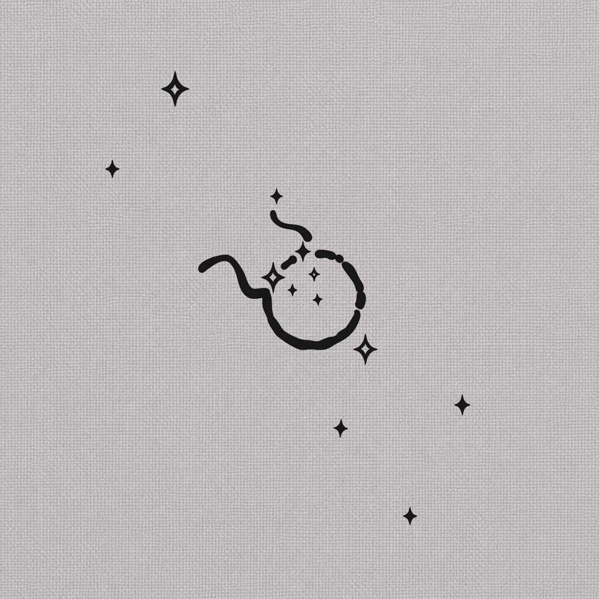 Taurus zodiac temporary tattoo featuring a minimalist Taurus symbol with small sparkling stars.
