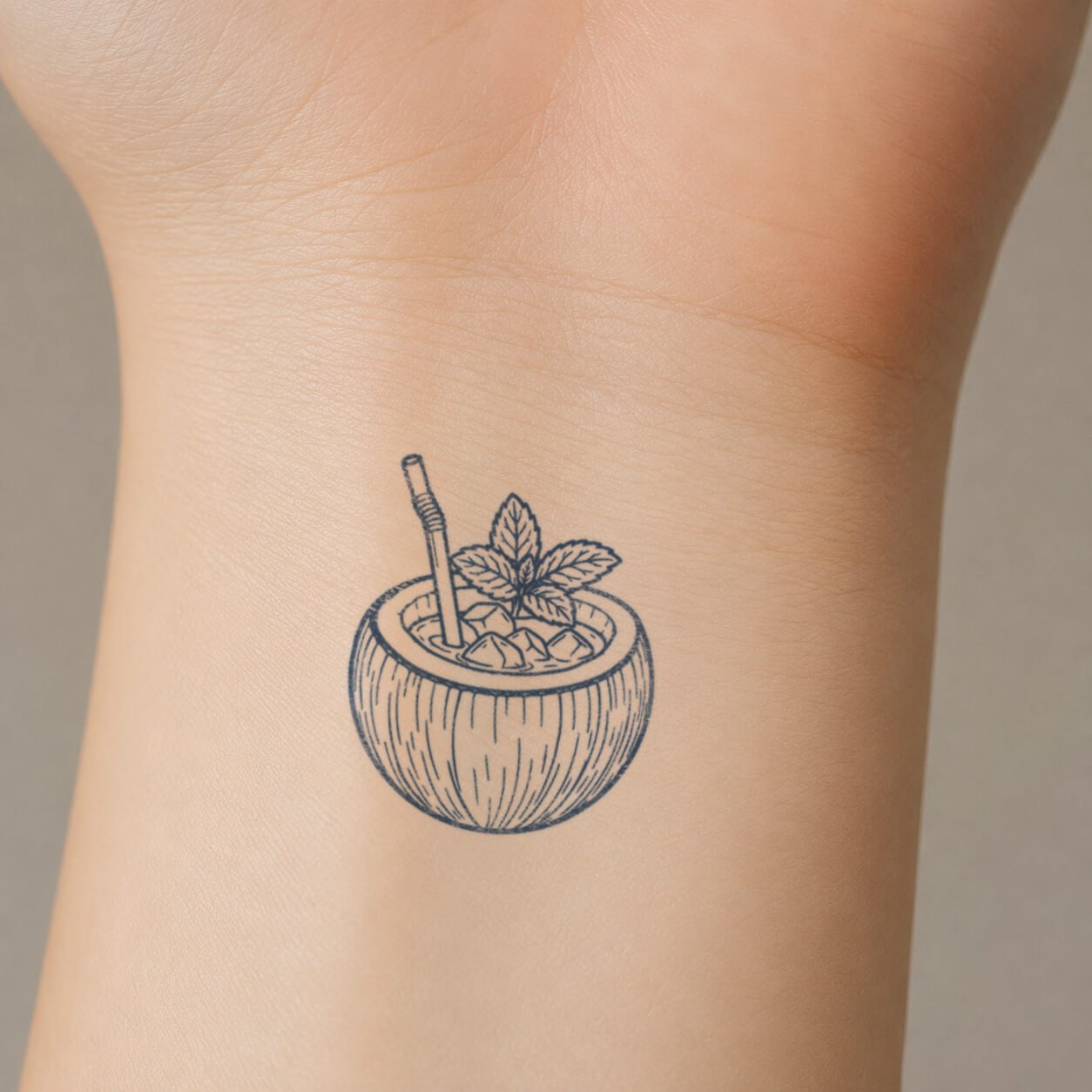 Detailed temporary tattoo sticker depicting a tropical coconut Drinks filled with ice and finished with a straw and mint leaves on the inner wrist.