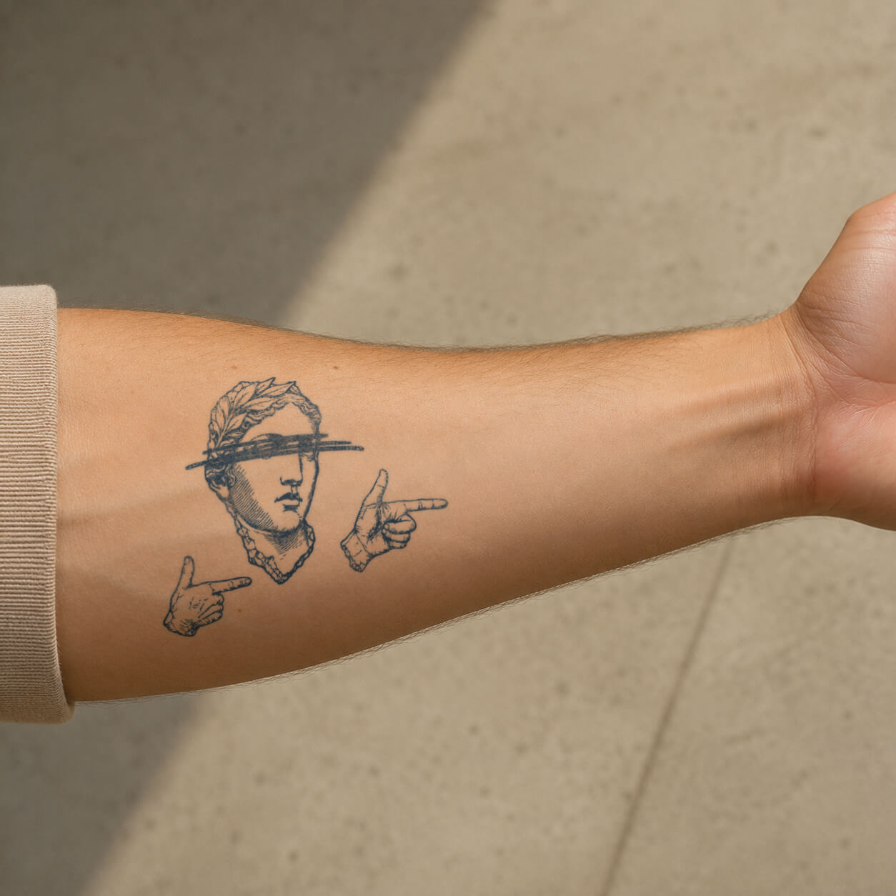 Classic statue portrait with pointing hand details placed on the forearm, featuring a unique fine line temporary tattoo design with artistic vintage styling.