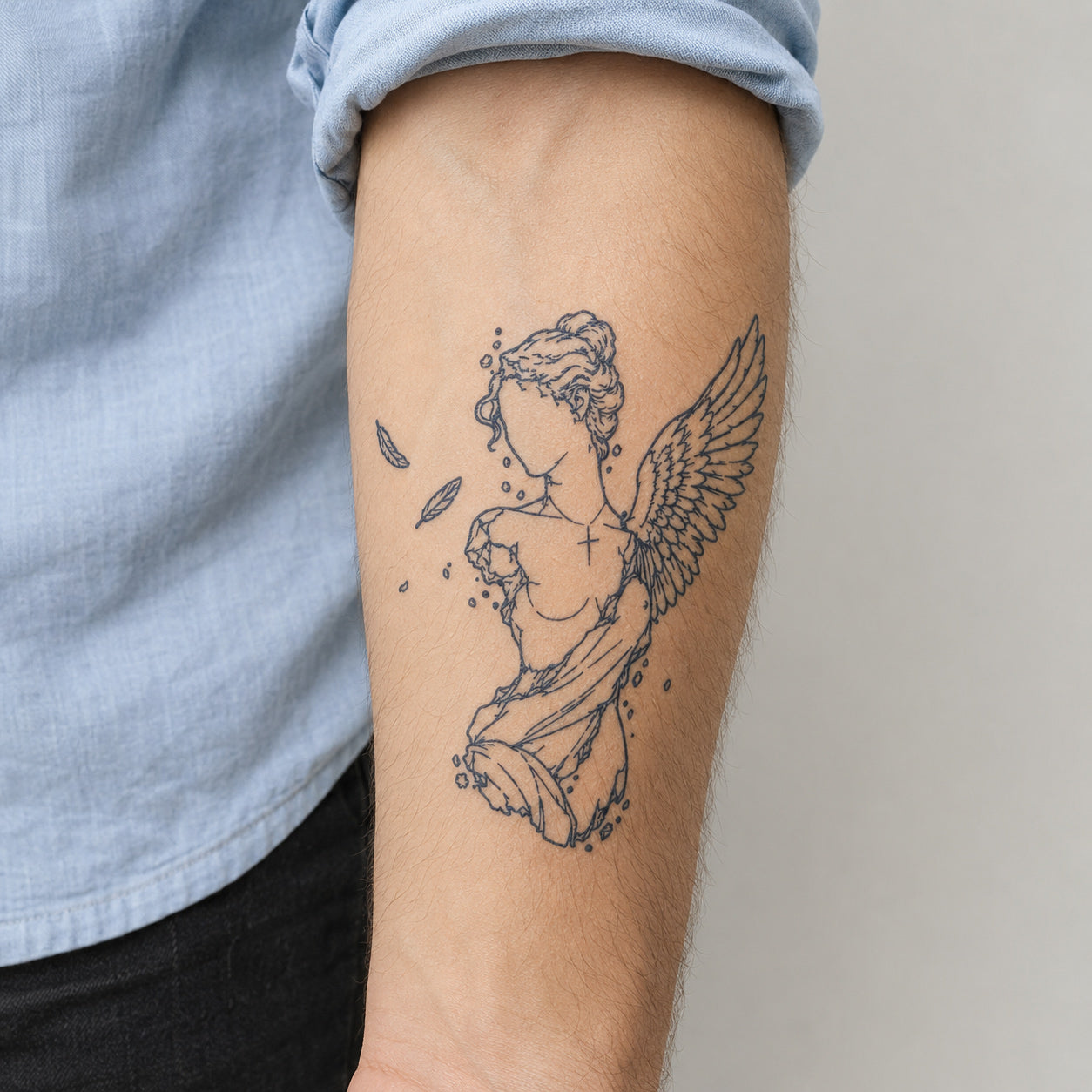 Fine line angel temp tattoo featuring a graceful winged figure design placed on the arm with delicate outlines and artistic details.