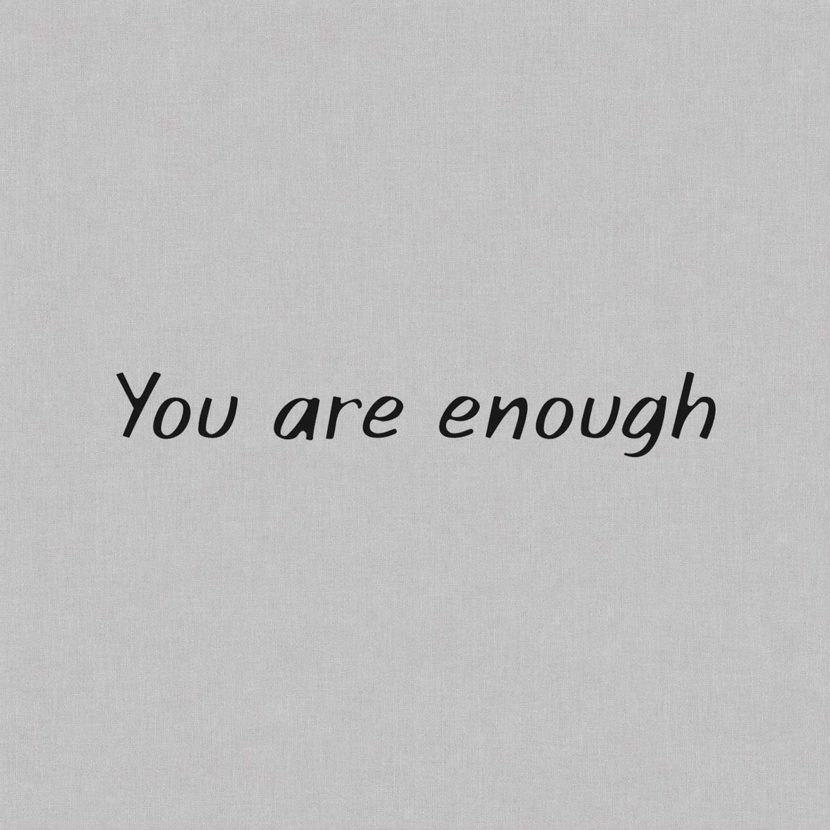 You are enough quote temporary tattoo featuring elegant handwritten lettering for a minimalist self-love tattoo design.
