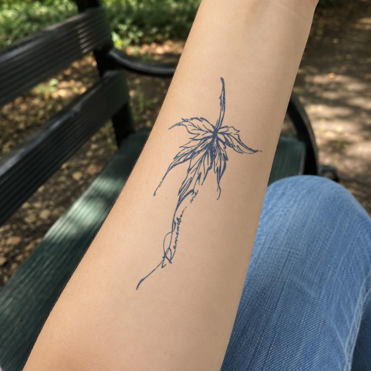 Elegant floral line non permanent tattoo worn on arm with soft artistic details