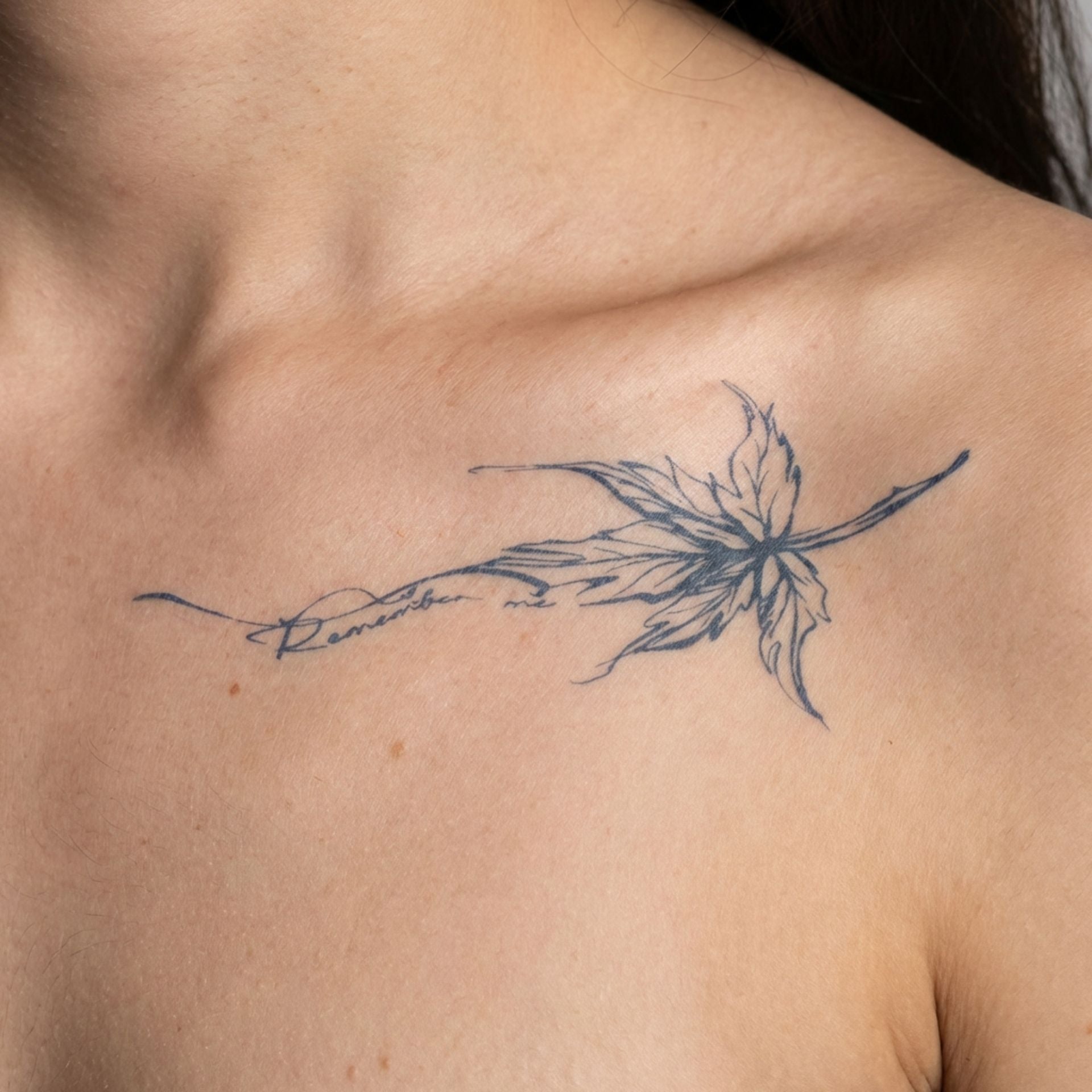 Elegant floral line non permanent tattoo worn on collarbone with soft artistic details