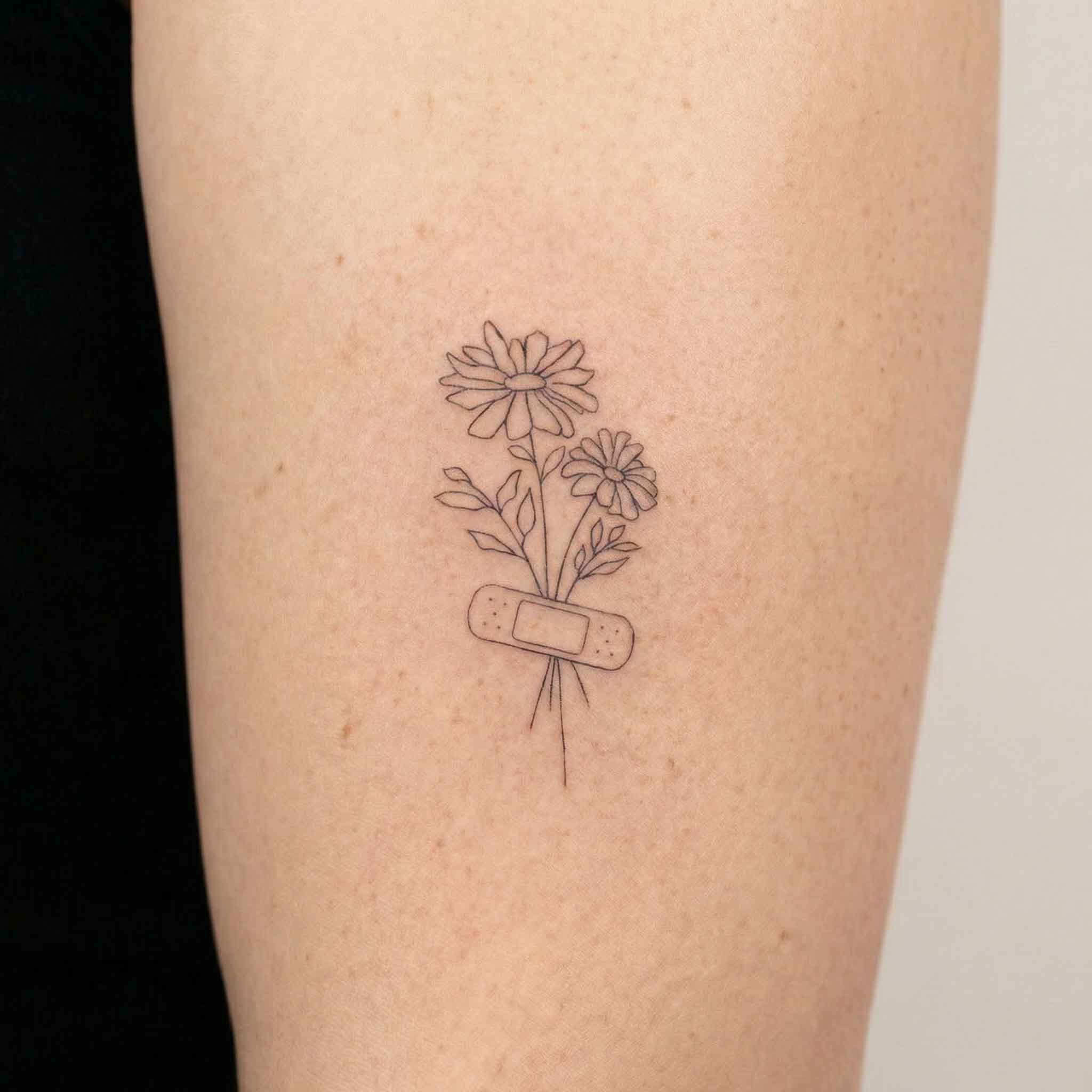 Daisy bouquet temporary tattoo on arm with minimalist floral line art