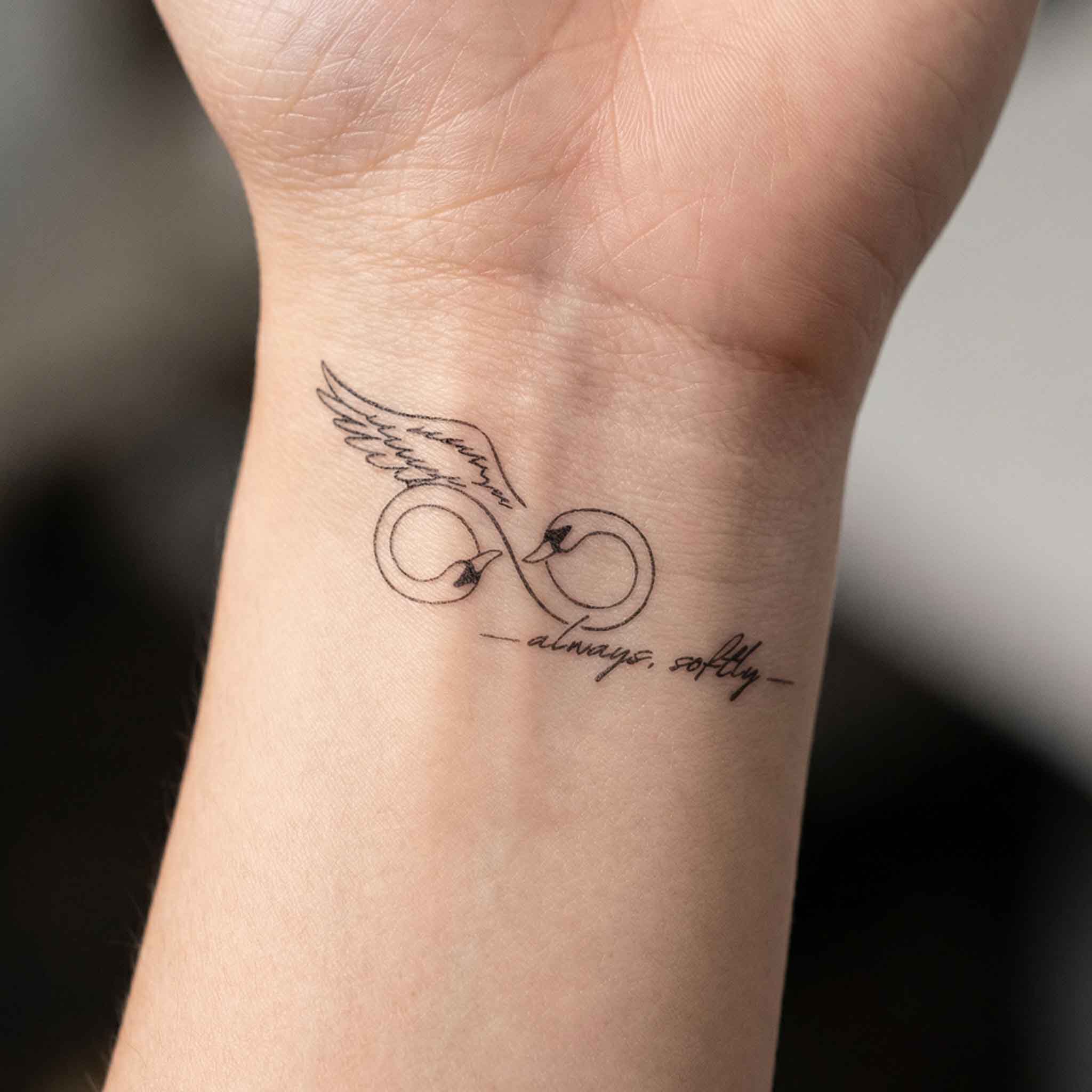 “always softly” swan infinity temporary tattoo sticker shown on skin.