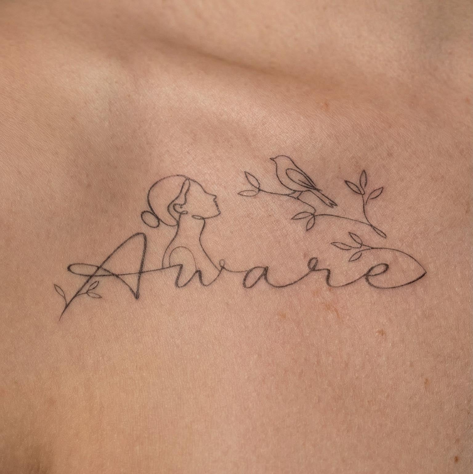 Minimal botanical quote fake tattoo worn on the clavicle with delicate linework