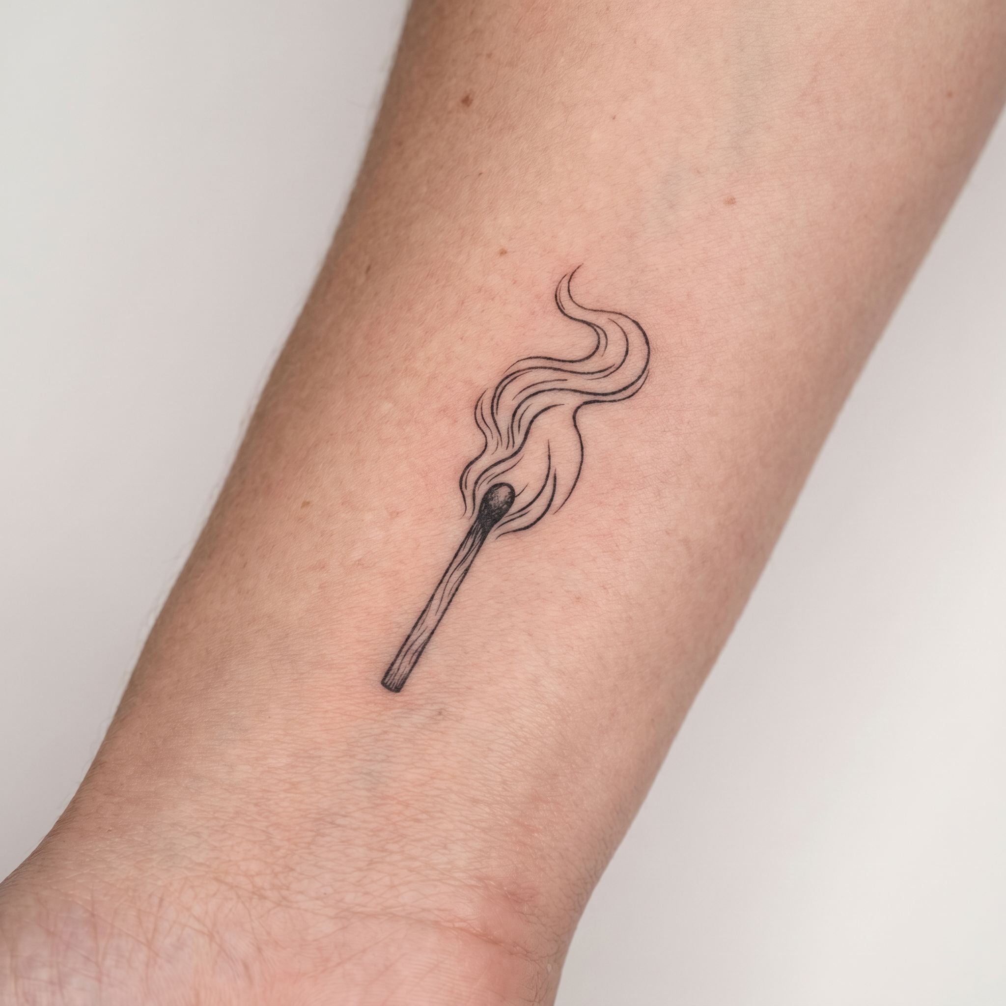 burning match temporary tattoo on wrist