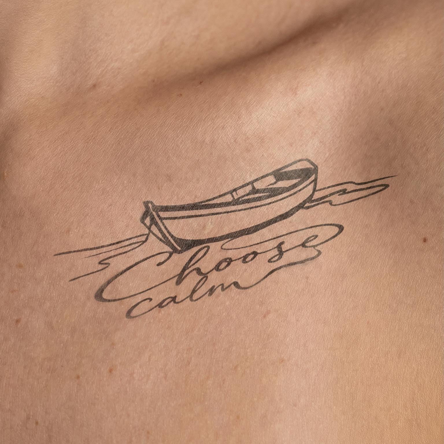 minimalist boat temporary tattoo with script "choose calm" fine line collarbone tattoo design