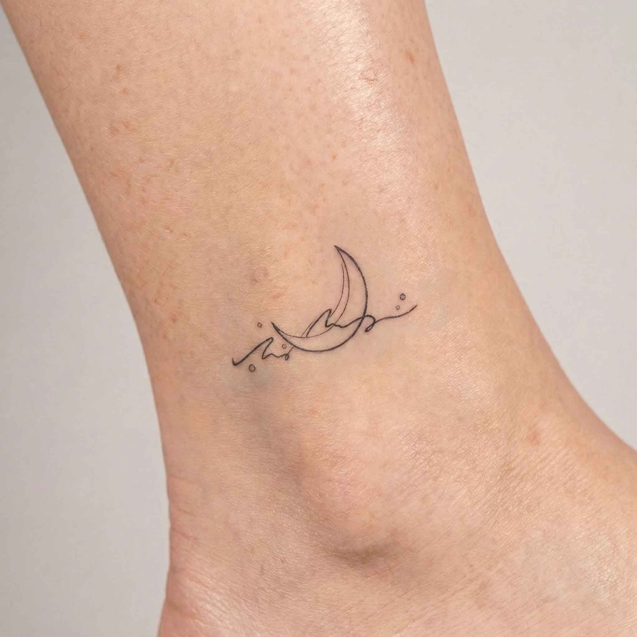 Crescent moon waves tattoo sticker shown on skin.