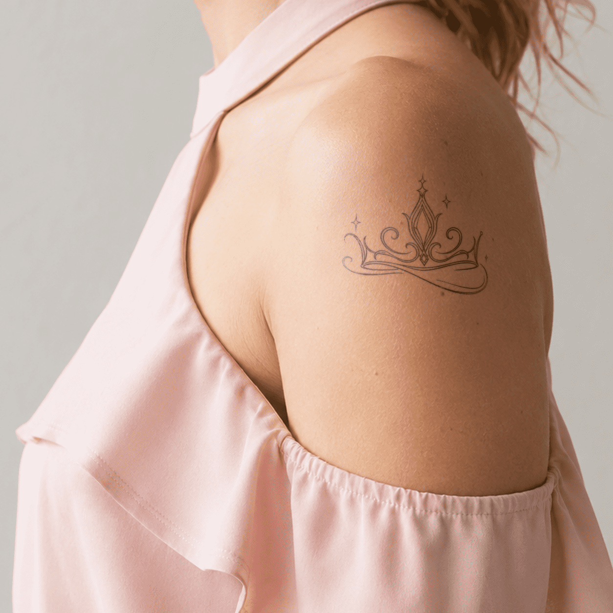 crown semi-permanent tattoo on shoulder