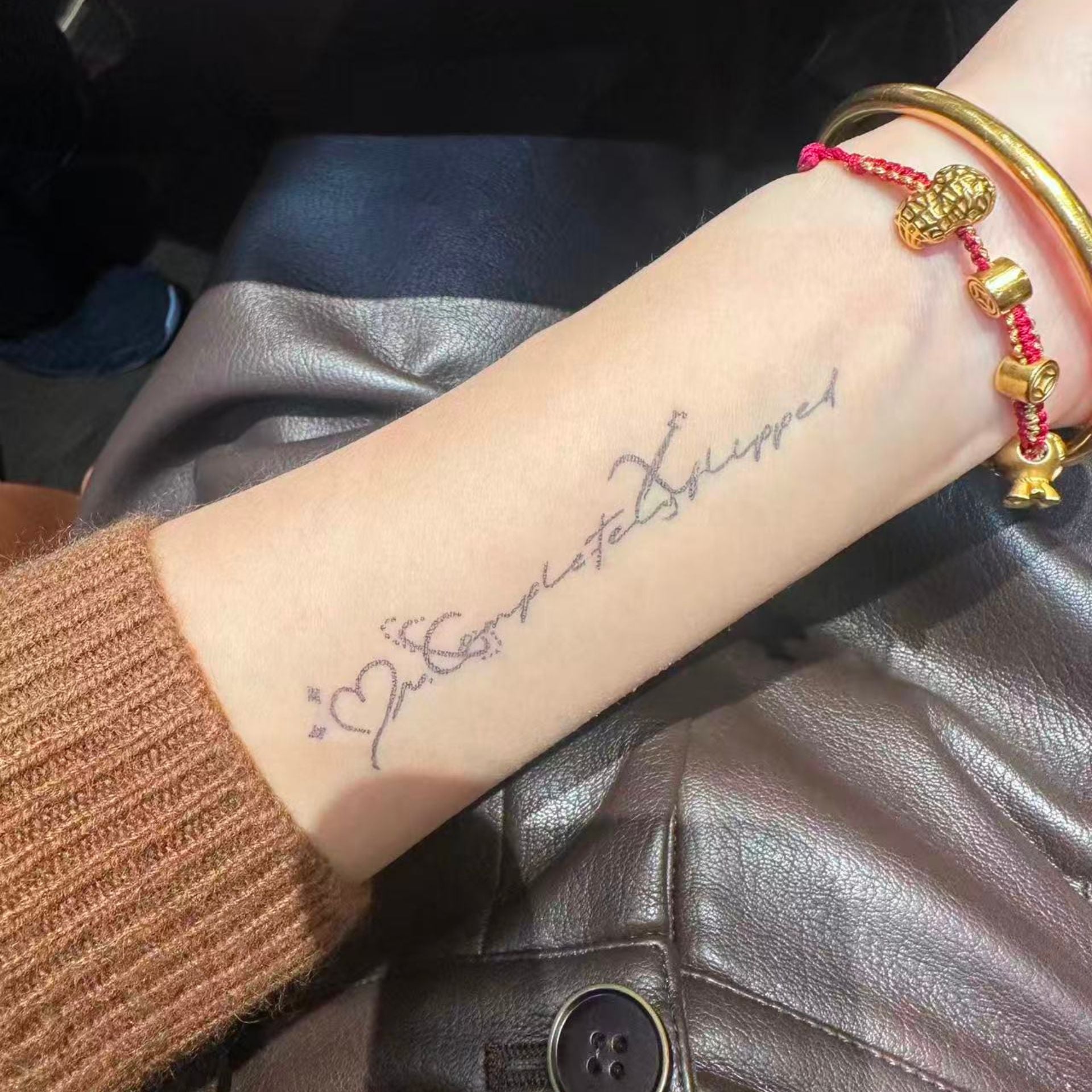 minimalist quote temporary tattoo on wrist in natural daylight