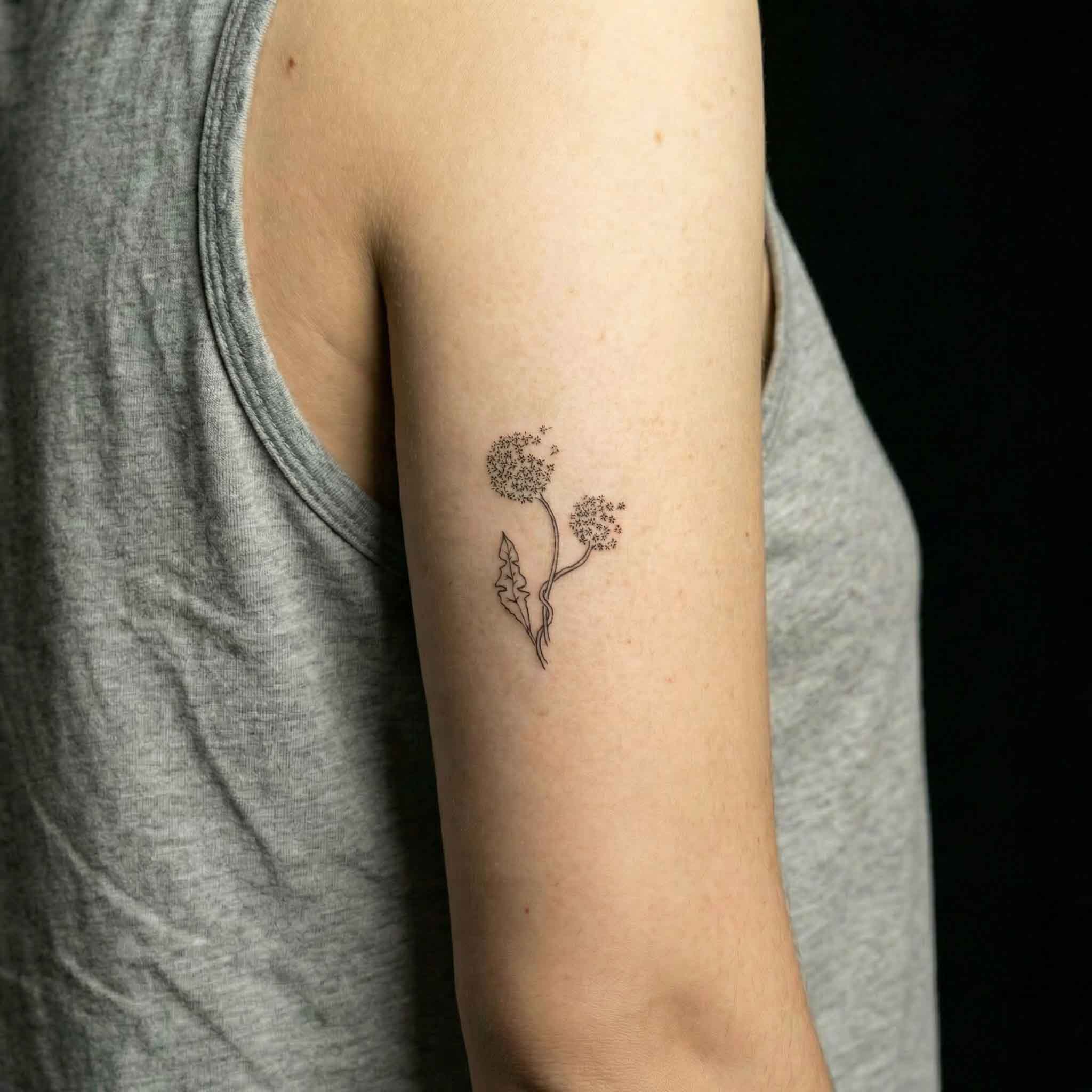 Minimal dandelion personalized fake tattoo worn on forearm with soft floral details