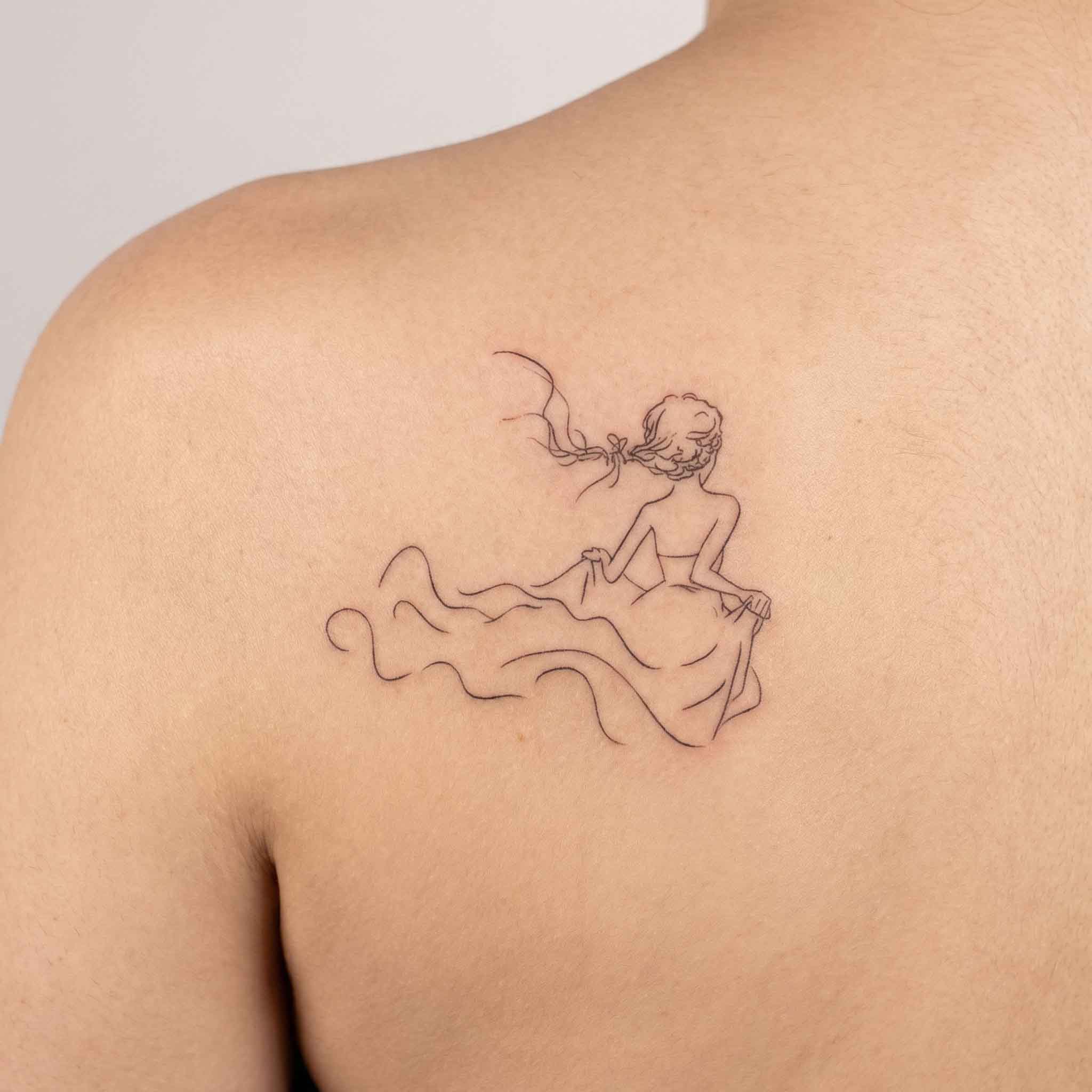 Minimalist feminine line art tattoo worn on back with soft flowing silhouette