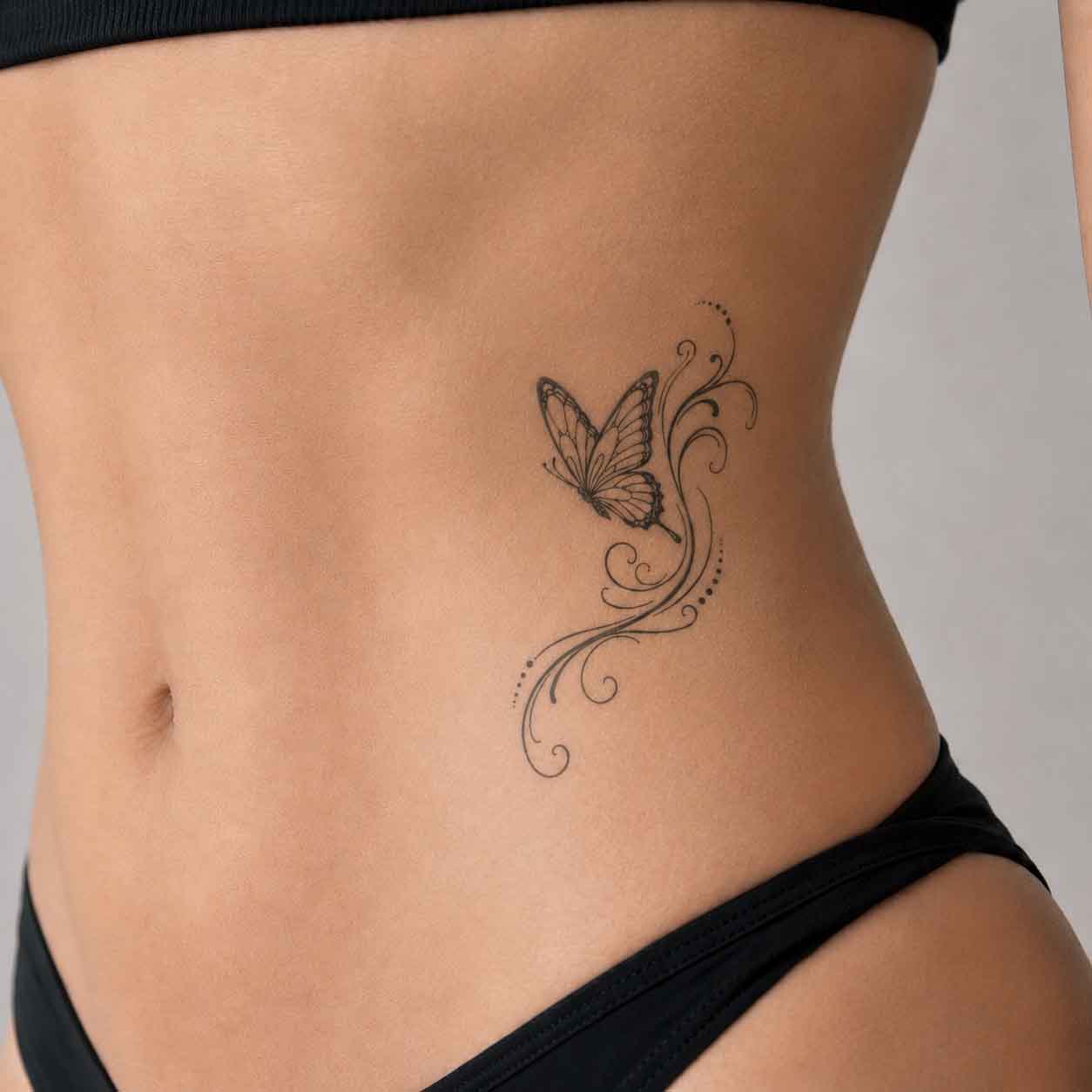 fine line temporary tattoos on abdomen featuring a minimalist butterfly design