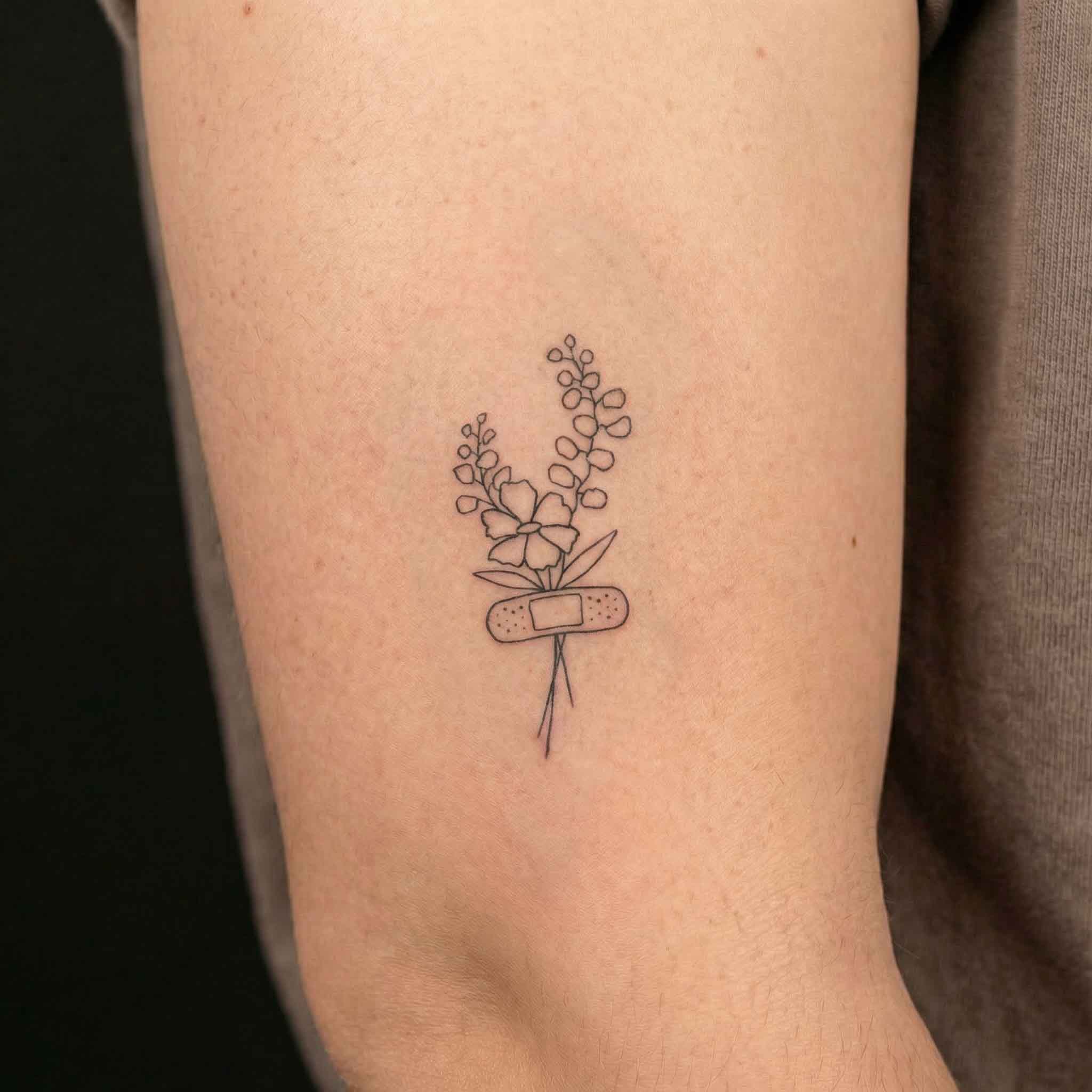 Floral bouquet temporary tattoo on arm with fine line flower design