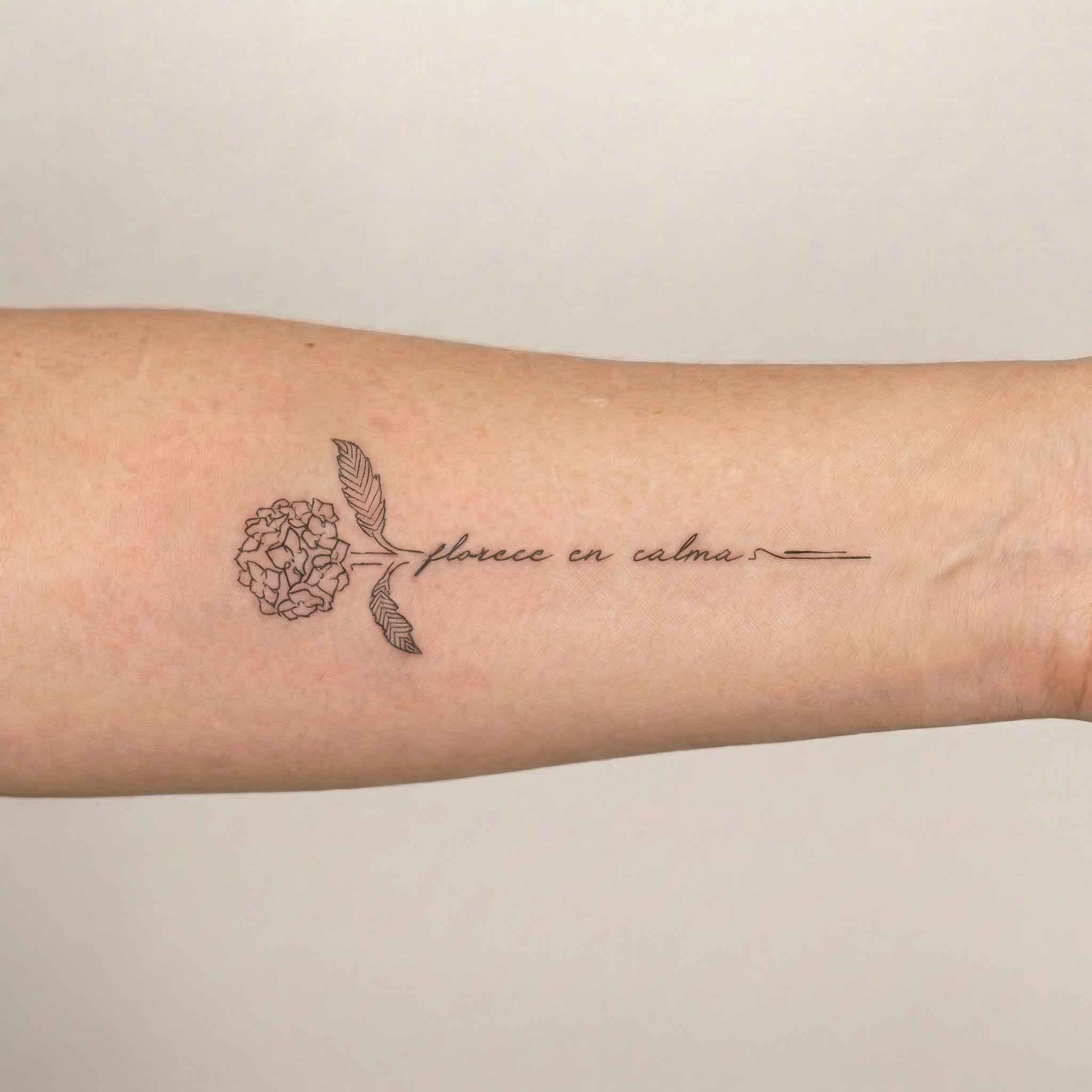 Elegant hydrangea flower tattoo worn on forearm with fine floral linework