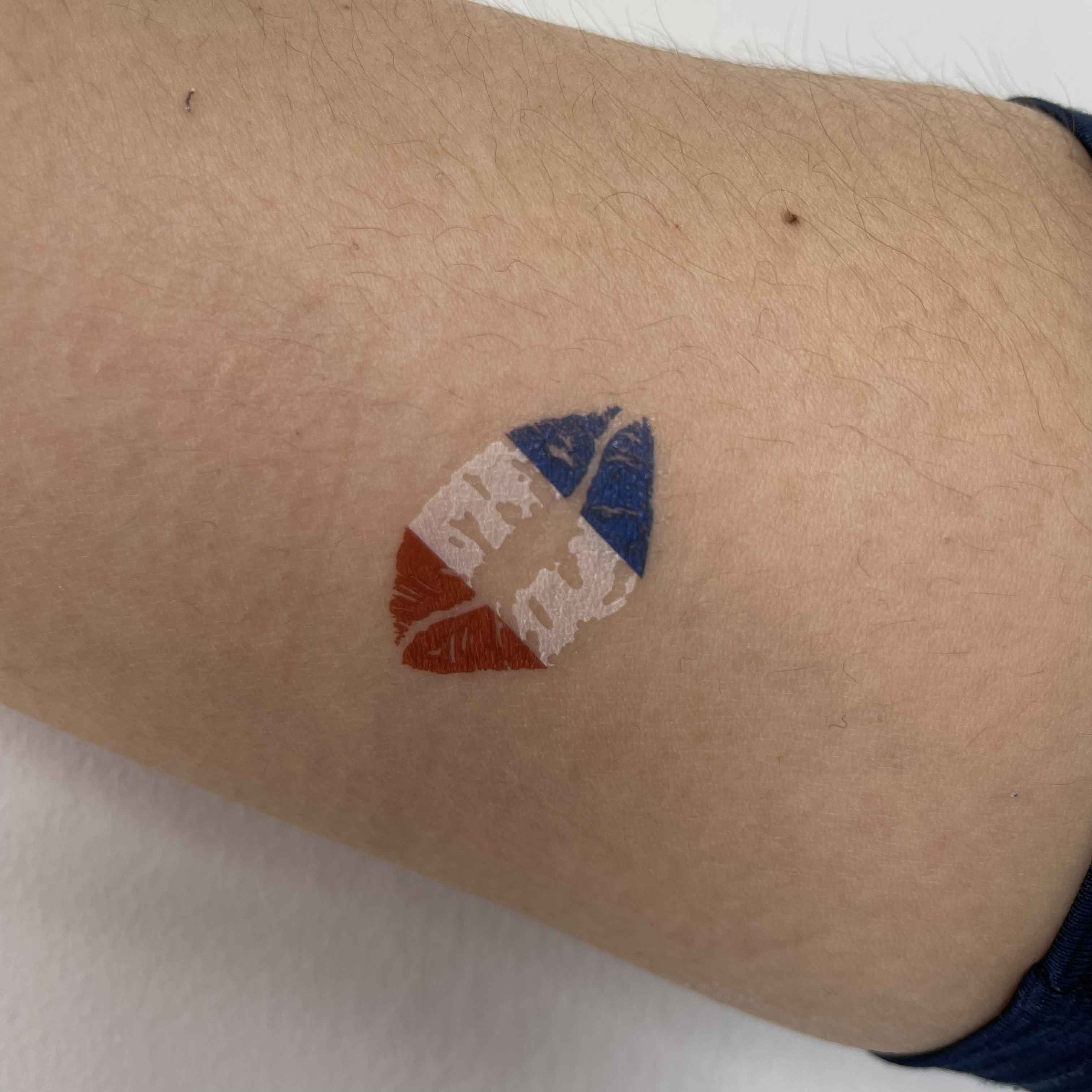 France flag heart temporary tattoo worn on arm for football game day and fan outfit look