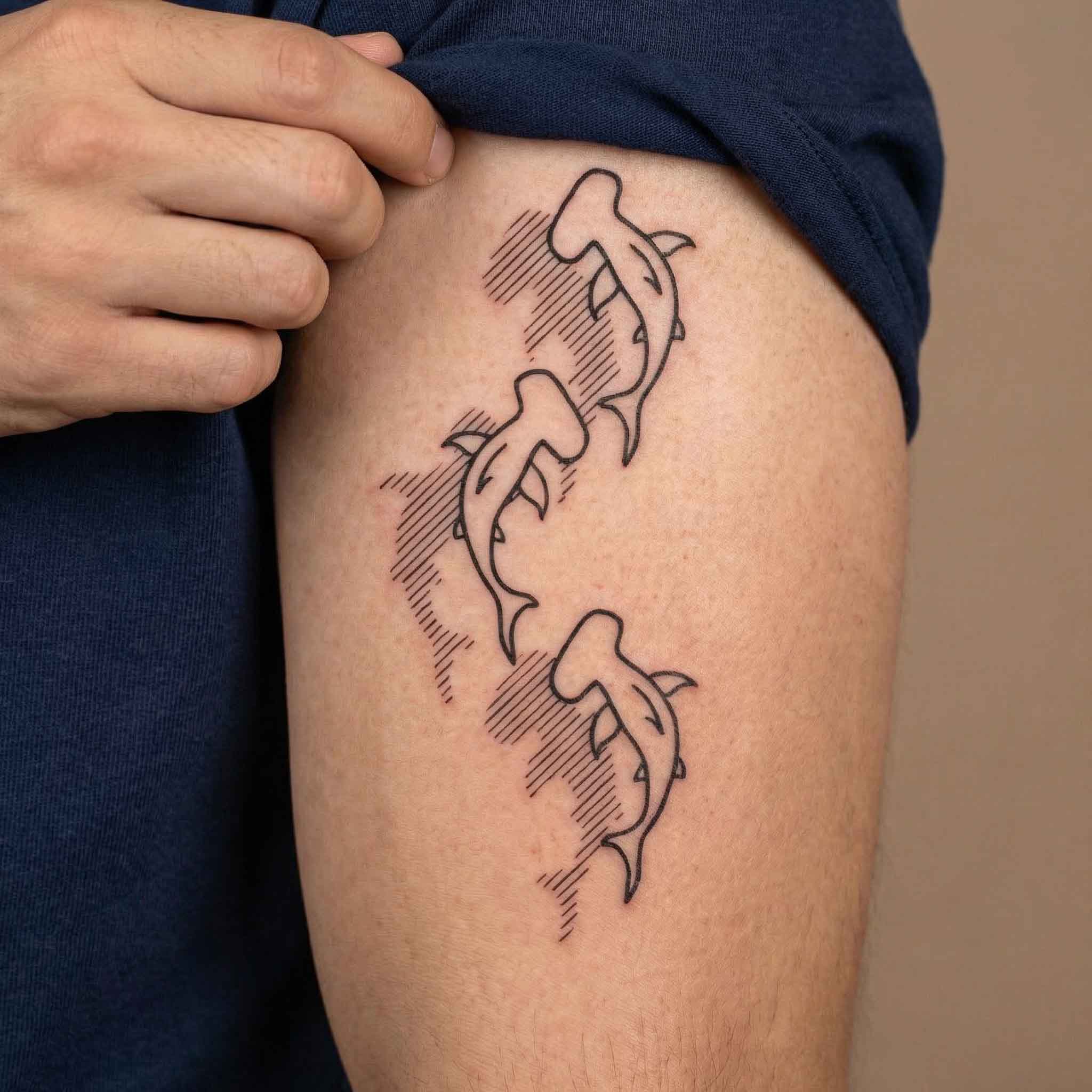 Hammerhead shark tattoo worn on forearm with clean marine linework