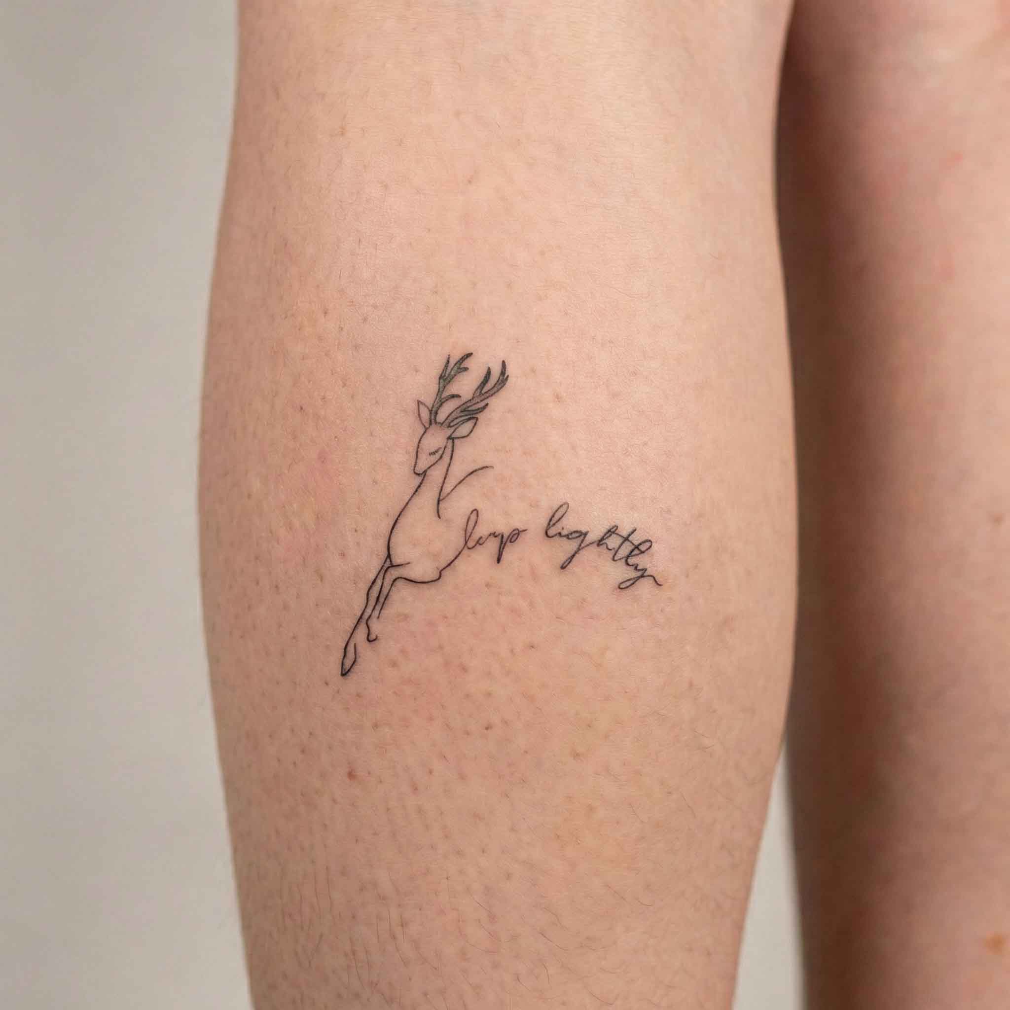 Minimal deer temp tattoo worn on the skin.