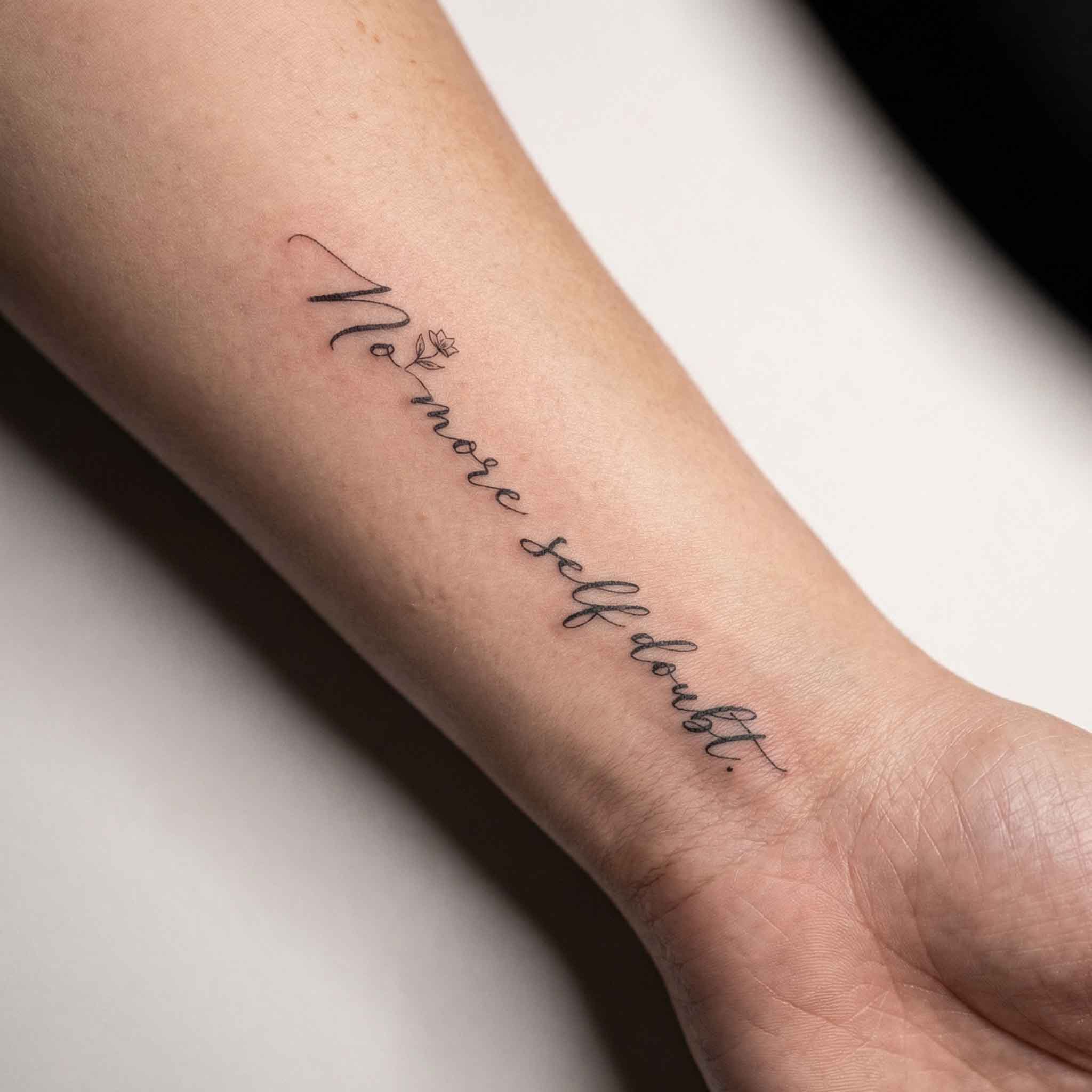 Minimal handwritten self-love quote temp tattoo worn on wrist