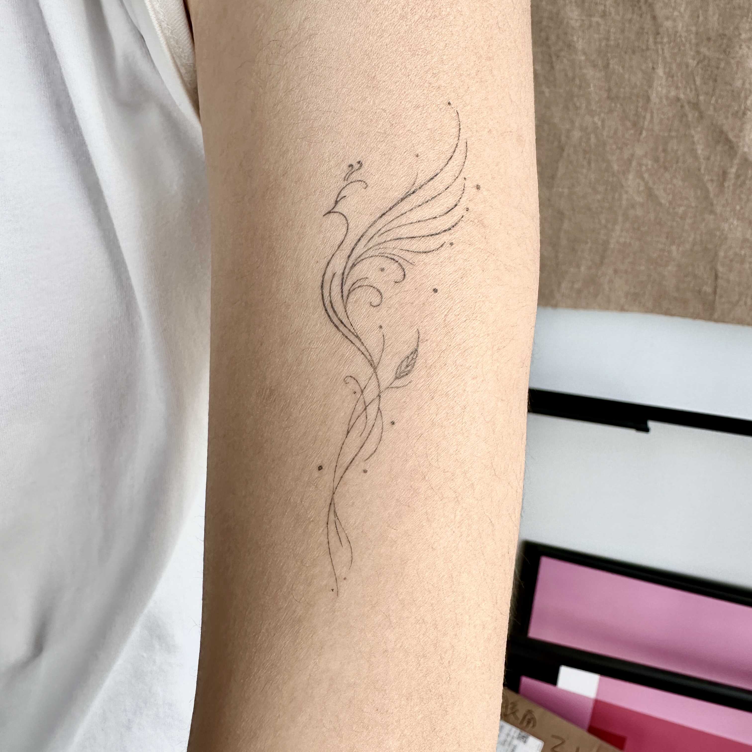 minimalist phoenix semi permanent tattoo on arm