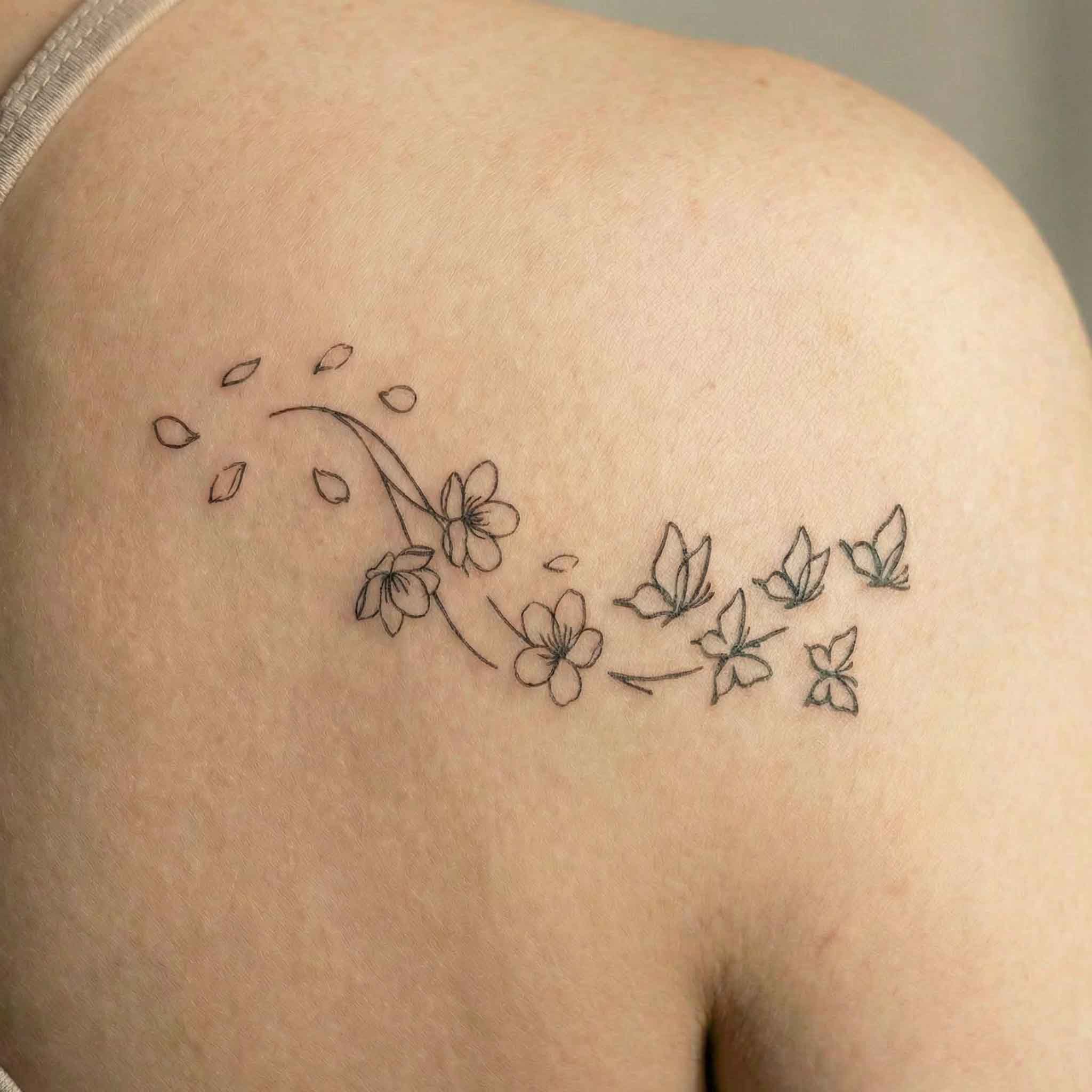 Small flower and butterfly temporary tattoos shown on skin.