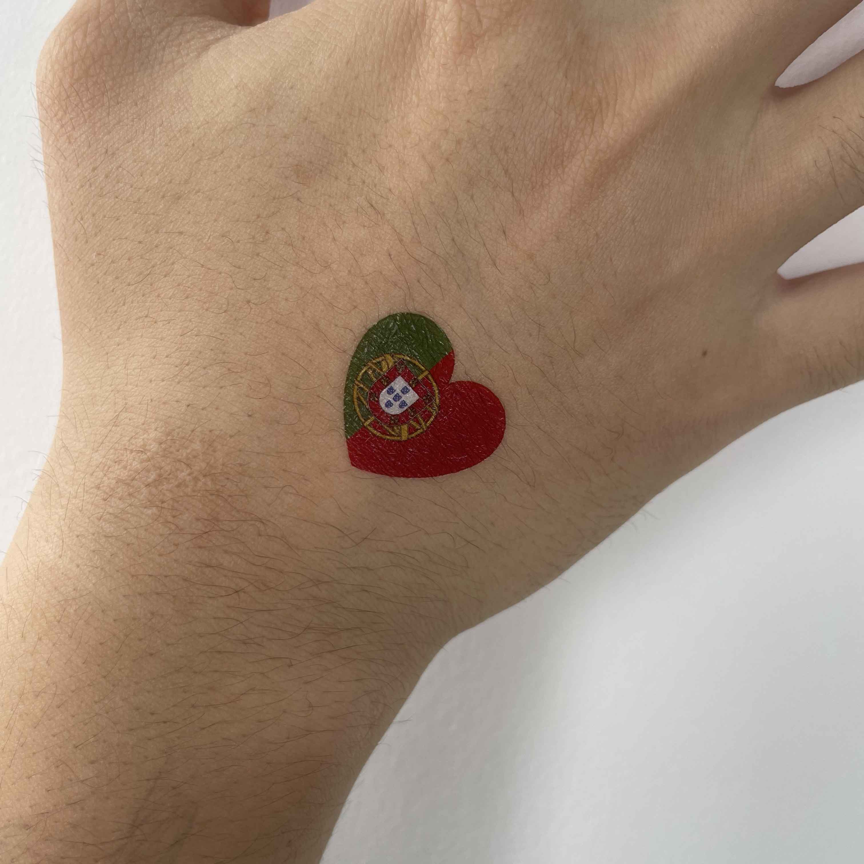 Portugal flag heart temporary tattoo worn on hand for football game day and fan outfit look