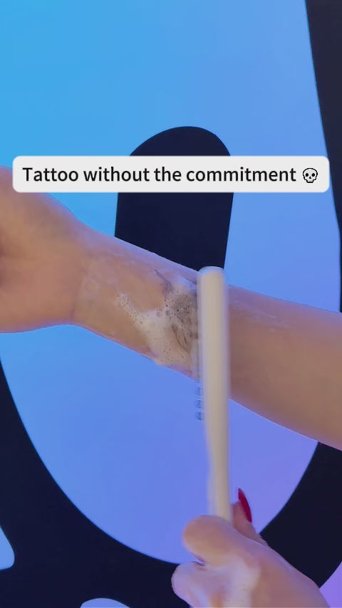 Temporary tattoo sleeves on display. Features a compass tattoo on a dark background, a biomechanical gear design on a light background, and a tribal dragon fake tattoo on a textured background. Waterproof body art for adults.