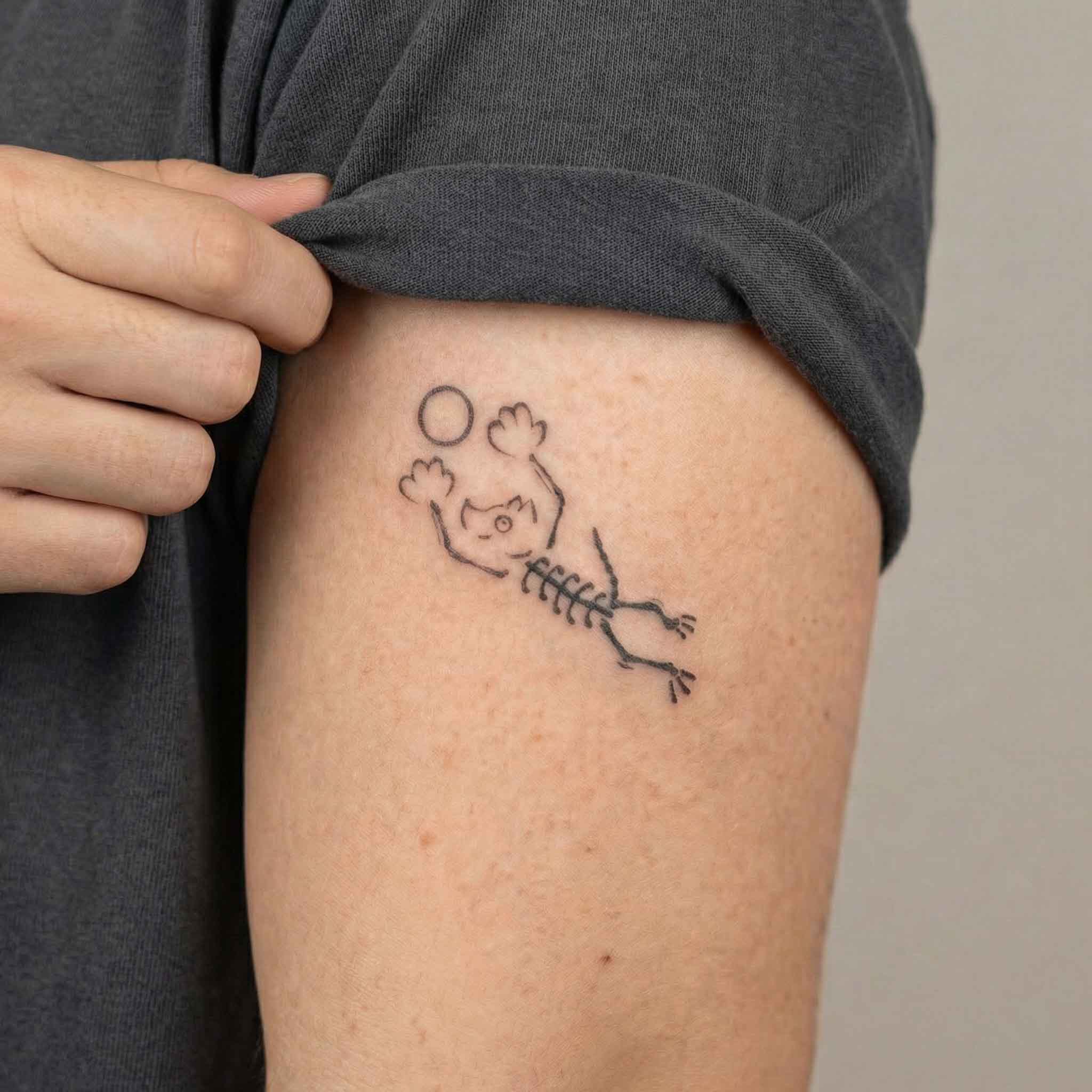 Small skeleton dog tattoo worn on arm in playful minimalist style