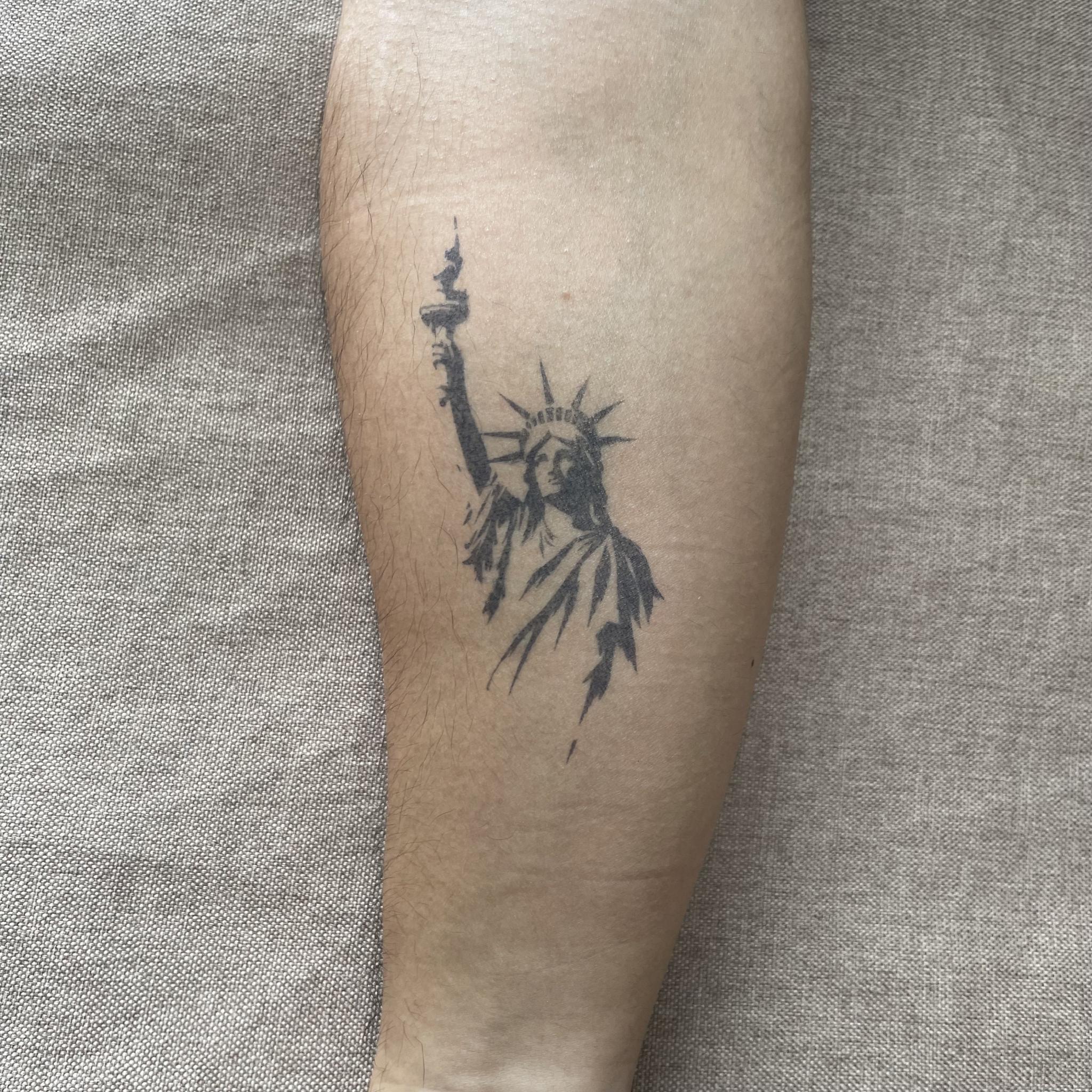 statue temporary tattoo with liberty on forearm 