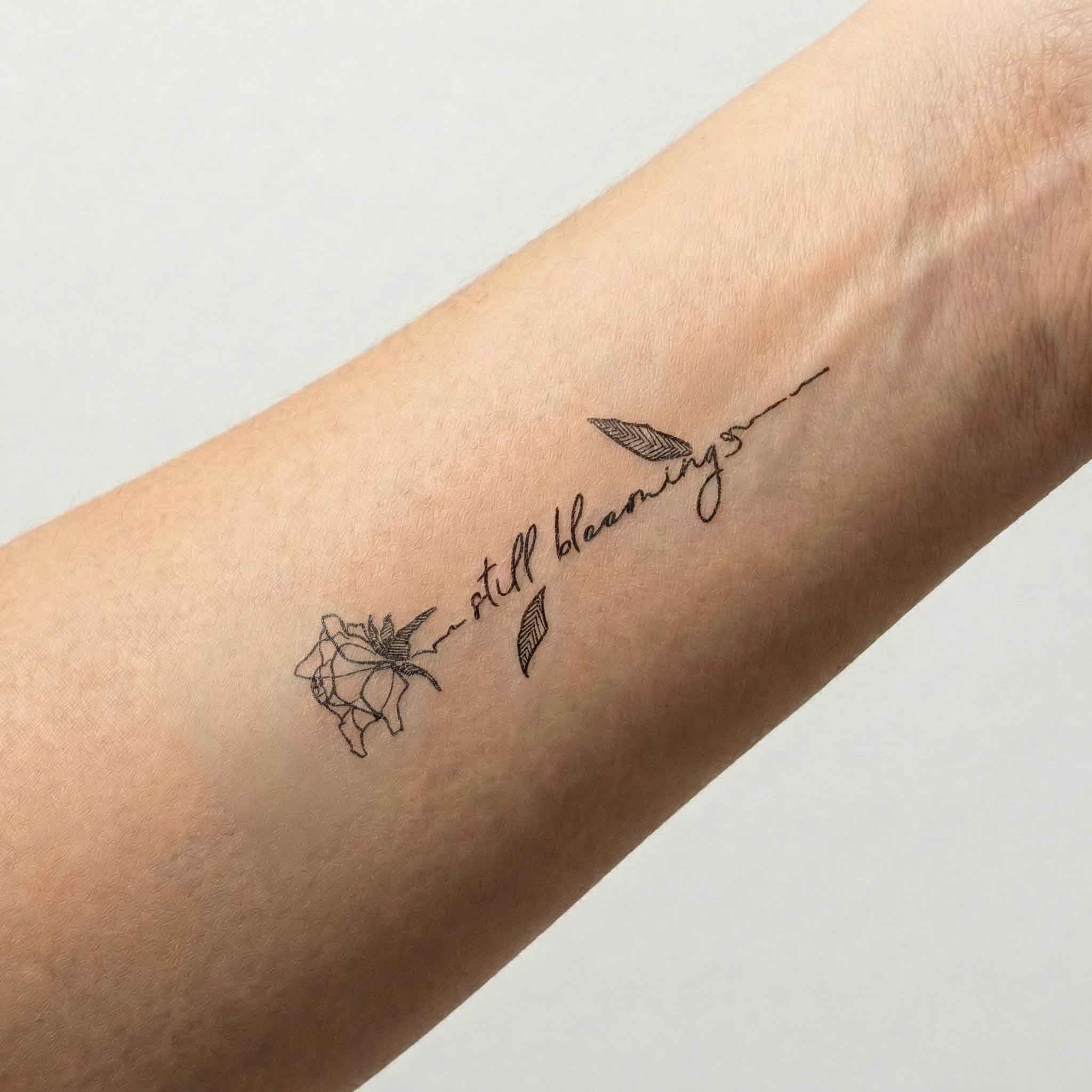 Elegant rose & word fake tattoo on arm skin