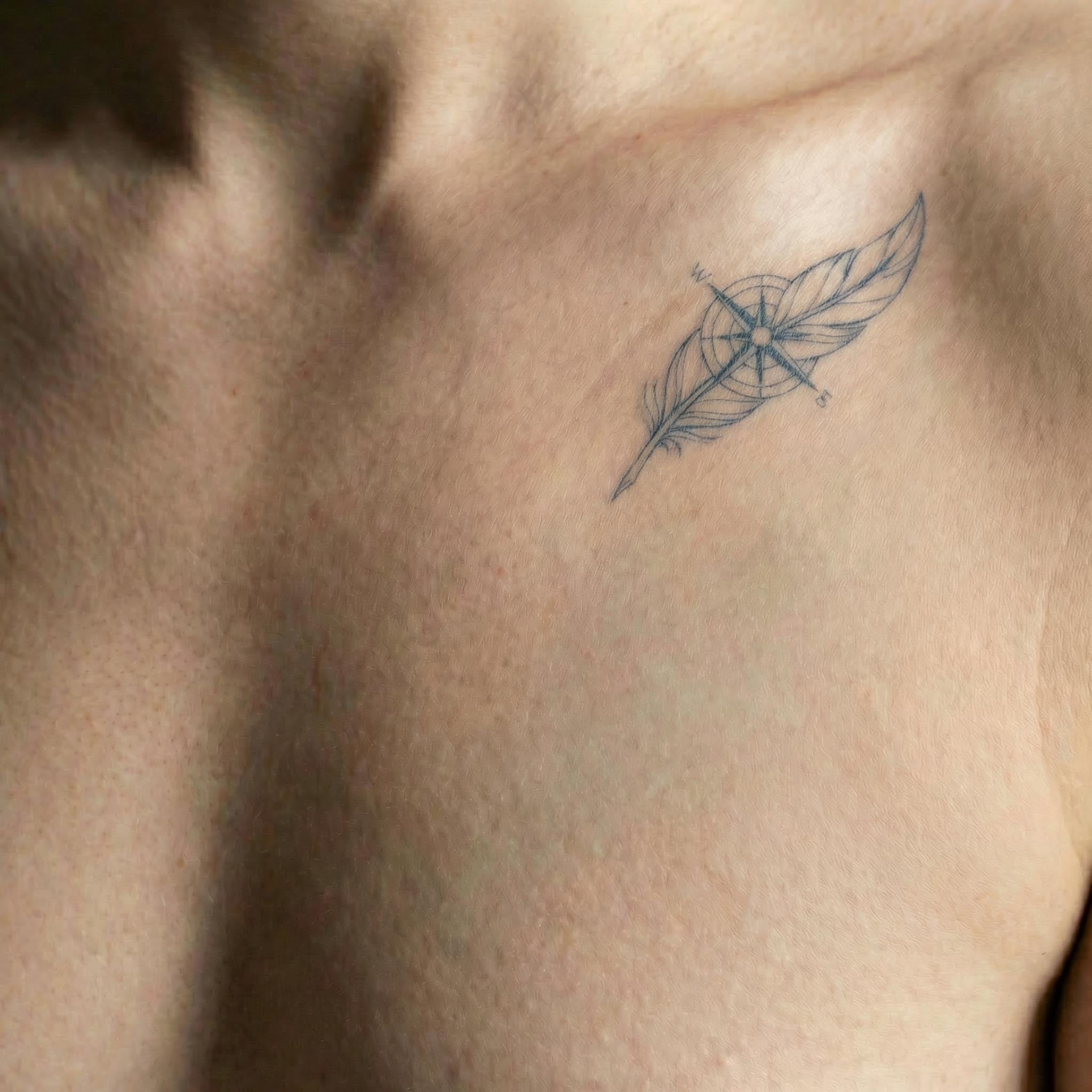 Small symbolic line fake tattoos worn on clavicle with clean minimalist details