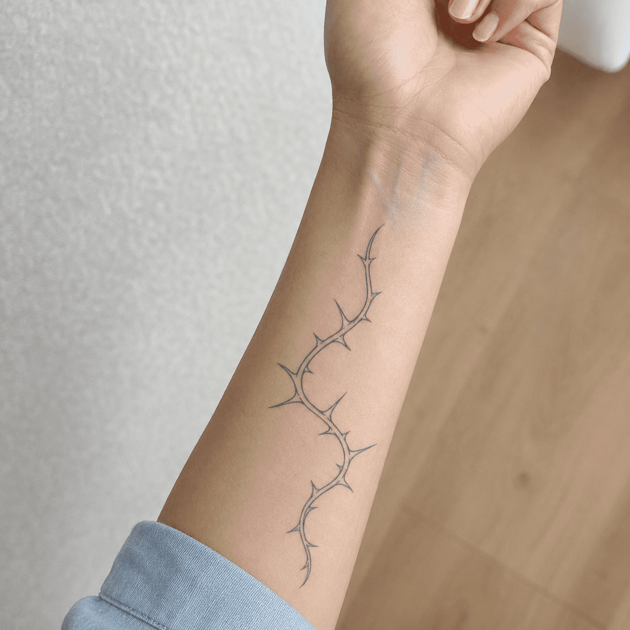 thorn vine temporary tattoo minimalist design on forearm 